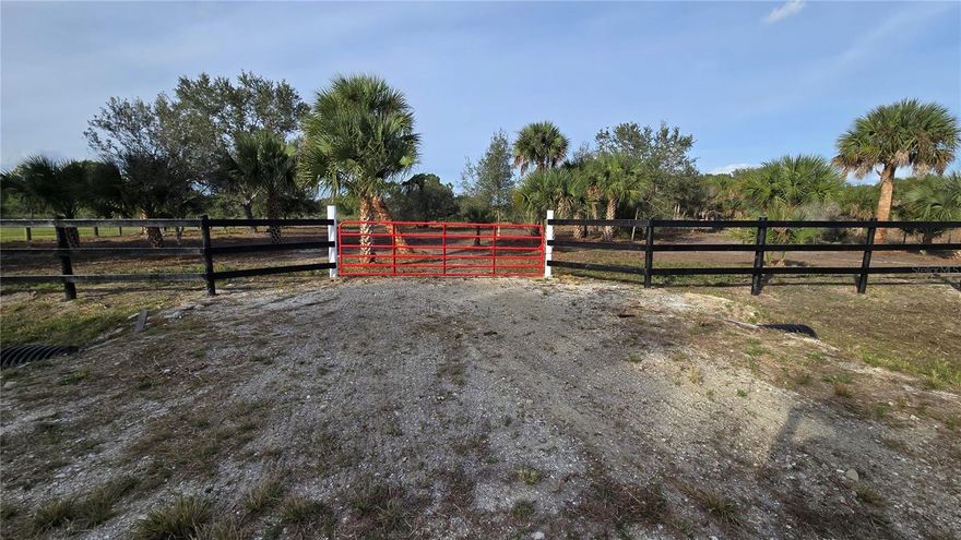 Located at 15783 NW 296th St, this premium 1.25-acre property is fully cleared, high-and-dry, and ready for immediate use. The landscape features large mature Live Oaks, Pines, and tropical palms, providing natural shade and privacy. Professional infrastructure is complete, including an installed heavy-duty culvert and a stabilized gravel entrance. The front perimeter is secured with high-quality board fencing and a red steel farm gate. This turn-key lot is a level and secure blank canvas for a custom home or agricultural project in a quiet area with no HOA.