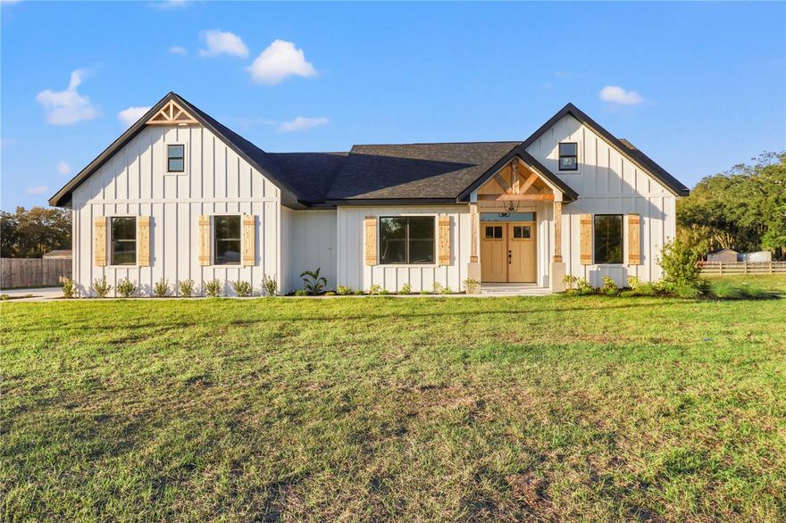 BRAND NEW!!! Yes, brand spanking new L Norman Adams Home Builders, Farmhouse series new construction home. Four bedrooms, two full bathrooms, two car garage all on a one half acre lot. You can say WOW, it’s ok, we do every time we pull up. Treat yourself to the best quality, construction, incredible location and all the top notch farmhouse details you are looking for. Open and split floor plan. Over 1800 square feet of living space. The living room is HUGE and has massive 3 paneled sliders that pour out to the lanai. The natural light inside is incredible. This home is stunning. The kitchen is amazing. Gorgeous quartz, over-sized, center island. The heart of this home is begging for birthday parties or dinner parties. The main bedroom is large without having to borrow space from the perfect en-suite and spacious walk-in-closet. The 4th bedroom at the front of the home would be ideal for an office or den, but can absolutely substitute as a bedroom if needed. Owens Corning architectural shingle black onyx roof. Florian USA brand - Eco Wood porcelain tile. All Sherwin Williams paint inside and out. ThermaTru Doors and MI Double Pane, Low E glass windows. Welbourn kitchen and bathroom cabinets. Solid CBS construction with Hardiplank front elevation and spectacular stained wood shutters and 8x8 cedar, entry-way columns. Just all around magnificent. By appointment only. Call us today. This home is intentionally priced below market value. The Builder is looking to move this one off the books and you reap the benefits. Tucked away in the HIGHLY sought after community of Willow Creek. Only one hour to Tampa or Orlando. Do not delay.  You WILL NOT match this exceptional home, for this price. Open and available 7 days a week.