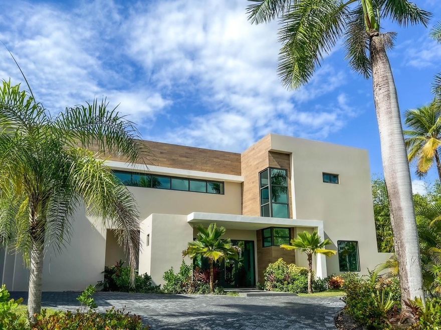 Brand new luxurious contemporary home with 7,700 sqf of air-conditioned living space for the discerning buyer. This architectural masterpiece, designed by renowned architect Jose Garcia, is surrounded by high-end multi-million dollar homes based in the sought after community of Dorado Country Estates, with direct golf cart access to the exclusive Dorado Ritz Carlton Resort. Inside living includes a great room and massive kitchen/waterfall island which anchors the home.  These rooms are complemented by a walk-in pantry, a family room and formal dining room, plus a ground floor guest suite. Luxury, high-end finishes include Subzero and Wolf appliances, European tile, custom Italian cabinetry, Kohler wall hung toilets and fixtures, and is equipped with Trane central air conditioning, a 60kw diesel generator and 1,200 gallon cistern. The Master Suite is a stunning retreat with views of the golf course and mountains, an over-sized walk-in Italian closet, walk-in shower, gorgeous tub, and Scavolini vanities.  All bedrooms are en-suite with tiled walls and walk-in showers. This beautiful estate consists of 9,500+ sqf construction space and sits harmoniously on a 2,000 sq meter lot (0.5 acre). The outdoor living area includes a covered patio and bathroom, and garage and driveway.