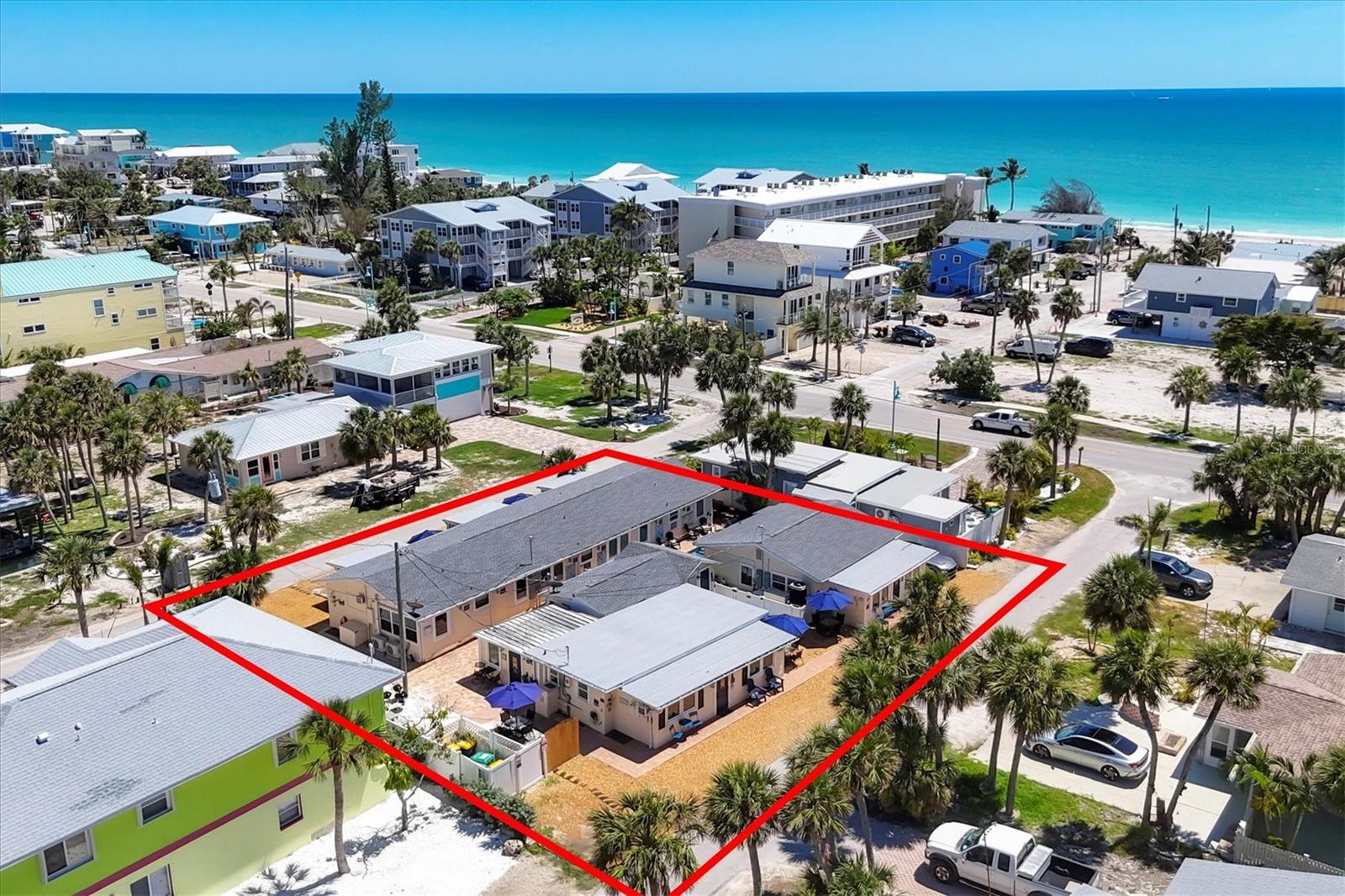 This is a rare and exciting opportunity to own a highly desirable income-producing property ($248,000 gross income in 2024) on Manasota Key, a serene and charming beach town ideally positioned between the Gulf of Mexico and Lemon Bay. With deeded beach and bay access, this unique six-unit compound offers guests and investors the best of both worlds—easy access to sun-soaked beaches and tranquil waters perfect for kayaking. This property has a strong rental history through platforms like VRBO, Airbnb, and Booking.com, offering investors an attractive stream of passive income in a high-demand vacation area. Consistently high guest review scores across platforms reflect strong guest satisfaction and a proven track record of repeat bookings—an attractive indicator of reliable income potential. Unlock the potential for strong returns with the option to lease the entire complex or maximize value by living in one unit while generating income from the others. The property features a total of six units spread across a triplex and two additional buildings, along with separate on-site laundry facilities. The triplex includes two 2-bedroom, 1-bath units and one 2-bedroom, 2-bath unit. Building 117 offers a 2-bedroom, 1-bath unit and two cozy studio apartments. Building 115, formerly a 2-bedroom, 1-bath unit, had a refrigerator fire and sustained damage and is being sold in “as-is” condition, providing a blank canvas for its new buyer to customize it to their liking, which will eventually make this property a 7-plex. Although building 115 is currently uninhabitable, all 6 other units are available for rent. All units are beautifully decorated with a fresh beachy vibe and are being sold turnkey furnished. They feature luxury vinyl plank (LVP) flooring installed in 2024, newer stainless steel appliances (2024–2025), updated kitchens with white shaker-style cabinetry, and pull-out sofa sleepers for additional guest accommodations. Most of the windows on the exterior perimeter are impact-resistant for added peace of mind. The pool pump and heater were replaced in 2024–2025, and the roofs were redone in 2020. Outdoor amenities are designed to enhance the guest experience, with a beautifully paved patio area, BBQ grills, outdoor showers, a ping pong table, chaise lounges, and dining tables. A spacious swim spa featuring a waterfall and massage therapy jets, installed in 2015, adds a luxurious touch. Guests also enjoy the use of four kayaks and a quiet seating area at the end of Friendship Lane—perfect for watching boats & dolphins cruise by. Manasota Key is a hidden gem along Florida’s Gulf Coast, renowned for its laid-back atmosphere, scenic beauty, excellent shelling, shark tooth hunting, and unforgettable sunrises and sunsets. Enjoy the ultimate in walkable living—just steps from the beach, Lemon Bay, and a variety of local restaurants. Whether you're heading to Stump Pass Beach or dining nearby, everything is within walking distance or a short free shuttle ride away—ideal for both vacationers and long-term guests. Sold “as-is” with rights to inspection, this property presents a compelling opportunity for investors seeking reliable rental income, long-term appreciation, and the unique lifestyle that only beachfront living can offer.