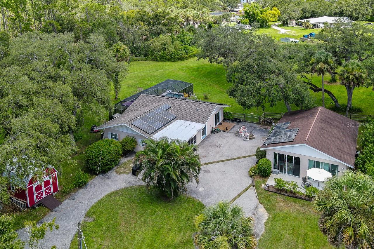 Seldom do we see an opportunity like this. Nature surrounds this multi generational retreat with separate quarters and spanning over 2 "well-manicured" acres. The possibilities are endless. The ample green space is perfect for animals so your four legged fur-family will love it too! Play Frisbee in the morning with the dogs or enjoy a game of volleyball or badminton in the evening with friends. You can't beat the all time favorite - just relax in the tranquility poolside or enjoy the peace and quiet with your favorite book. The "owned" photovoltaic solar panels create a comfortable environment inside and are easy on the wallet, saving you money every month!! Enjoy the freedom of less rules and regulations since there is NO HOA or CDD, and NO FEES! There are two sheds on the grounds for substantial storage and the property is already connected to public water. Come check it out for yourself and let your imagination run free.