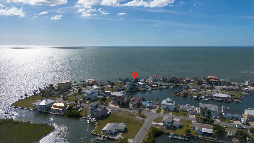 Exceptional Gulf-Front Lot – Rarely available and highly sought after, this 8,125 sq ft Gulf-front lot offers 65 feet of prime water frontage with stunning West/Southwest views. Picture yourself enjoying breathtaking sunsets over the Gulf year-round, all from the comfort of your own property. Plus, this lot comes with a deeded boat slip on the East side of Gulf Winds Circle, perfect for boating enthusiasts.

This unique location, nestled in the heart of Hernando Beach, offers a rare opportunity to live your waterfront dream. The Nature Coast is renowned for its natural beauty and is a haven for boaters, fishermen, and wildlife lovers alike. Imagine watching dolphins or manatees swim by while casting a line right from your backyard. Some other wildlife that you’re likely to encounter in the area may include a variety of birds, stingrays, or crabs, offering a true taste of coastal living. 

With no HOA restrictions, you can enjoy the freedom to keep your boats, trailers, RVs, and golf carts, right at home. Properties with true Gulf frontage on this road are rarely on the market, making this an exceptional opportunity.

While the existing home has sustained storm damage and its structural integrity cannot be guaranteed, this property presents a great opportunity for a new build. The highest and best use is likely rebuilding an elevated home, which will only enhance the incredible water views. Whether you're envisioning a luxurious primary residence, a vacation retreat, or a short-term rental, this lot offers endless possibilities. And with no HOA to restrict short-term rentals options, some nearby homeowners are capitalizing on this opportunity.

Dreaming about designing your custom home with an infinity pool overlooking the Gulf, unwinding in a hot tub while watching the sunset, or gathering with friends and family for a waterfront cookout. This is your chance to create the ultimate lifestyle in one of the Gulf Coast's hidden gems.

Hernando Beach is a peaceful yet active community, where coastal charm meets natural beauty. While the area doesn’t have a traditional beach, it offers several restaurants, bars, and coastal shops along Shoal Line Blvd—just a short golf cart ride away. For outdoor adventurers, the famous Weeki Wachee Springs are only 5 minutes away, offering crystal-clear waters perfect for swimming, paddleboarding, and kayaking.

Conveniently located less than 10 minutes from local grocery stores, restaurants, and medical facilities, this property is also just an hour from Tampa, Clearwater, and St. Petersburg. Don’t miss your chance to own this rare Gulf-front lot and create the waterfront lifestyle you’ve always dreamed of.