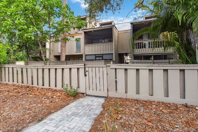 Welcome to the enchanting, guard-gated community of The Springs, surrounded by 400 acres of lush forest, offering an ideal blend of natural beauty and modern amenities. This unique community features scenic walking paths, a private spring, a two-mile creek perfect for kayaking, and equestrian facilities with a private stable for horse boarding—creating the dream lifestyle you’ve been seeking.
Nestled within this sought-after setting, discover a beautifully updated first-floor condo at 108 Crown Oaks Way, Longwood, FL. This one-bedroom, one-bathroom home boasts an open kitchen with granite countertops, stainless steel appliances, and ample white cabinetry. The living space offers all-hard flooring, recessed lighting, and an airy layout that flows seamlessly to a screened-in entrance and back patio.
The spacious primary bedroom includes dual closets, a front sitting area with sliding doors, and motorized blackout shades for added privacy. The updated bathroom is complete with a sleek glass shower door and modern single-sink vanity. Outside, enjoy a fenced-in yard with a mix of brick pavers and artificial grass—just steps from the community’s 8-ft deep pool.
One of the standout features of this home is its pet-friendly environment, perfect for those who love to walk their pets. With expansive open green spaces and scenic trails throughout the community, it’s a paradise for both you and your furry companions.
Additional conveniences include an enclosed laundry area with washer and dryer, a one-car carport with extra parking nearby, and access to a wide range of exclusive amenities. Located less than five minutes from I-4, Publix, and top-rated schools, and just a short drive to Wekiva Island, this is the perfect home for nature lovers seeking both tranquility and accessibility.