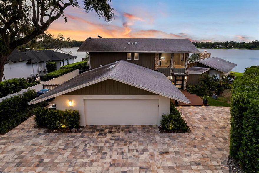 Welcome to this exquisite luxury waterfront home that seamlessly blends midcentury modern charm with contemporary design, offering a truly unique and sophisticated living experience. COMPLETELY REMODELED by E2 Homes between 2018 and 2019, this home is nestled on the shores of Lake Berry, this architectural masterpiece embraces the beauty of its natural surroundings, providing breathtaking panoramic views of the sparkling waters and lush landscape. As you step inside, you are greeted by an abundance of natural light streaming through the floor-to-ceiling windows, illuminating the open-concept living spaces. The interior boasts a perfect harmony of clean lines, sleek finishes, and warm, organic materials, creating an inviting and comfortable atmosphere. The heart of this home is its spacious and gourmet chef's kitchen, complete with state-of-the-art bosch appliances, custom cabinetry, and a large center island, perfect for entertaining guests or enjoying intimate family meals. Designed for relaxation and entertaining, the living room showcases panoramic Lake views that transition to the expansive outdoor living spaces through sliding glass doors. Step out onto the grand Lanai, where you'll find a private oasis with a sleek pool which was completed in 2022, that appears to merge with the lake, offering the perfect spot to unwind and savor breathtaking sunsets. The master suite is a true retreat, boasting its private patio overlooking the serene waterfront. The spa-like ensuite with not just one but two bathrooms that feature luxurious fixtures, a soaking tub, a walk-in steam shower, a contemporary design, and a double closet space, ensuring a tranquil and functional space for rejuvenation. Additional bedrooms offer ample space and stunning views, providing comfort and privacy for family members and guests alike. This home also boasts sustainable design elements, including energy-efficient windows and eco-friendly materials, making it an environmentally conscious choice without compromising on luxury and style. With direct access to the waterfront, you can enjoy various water activities such as boating, fishing, and kayaking right from your private dock. Located in the Waterbridge Neighborhood, this luxury waterfront home is just a short drive from Downtown Winter Park, and Baldwin Park, offering the best of both worlds – a serene lakeside retreat and easy access to upscale dining, shopping, and cultural attractions. Don't miss the opportunity to own this one-of-a-kind luxury waterfront property, where midcentury modern aesthetics meet contemporary luxury living. Immerse yourself in the beauty of nature and experience the epitome of lakefront sophistication. Schedule your private tour today! This home was completely remodeled in 2018 -2019 By E2 Homes, the roof was replaced in 2018, the ACs in 2018, the doors, windows, and sliders were replaced in 2018, the plumbing was repiped in 2018, new electrical was in 2018, the pool was completed in 2022.