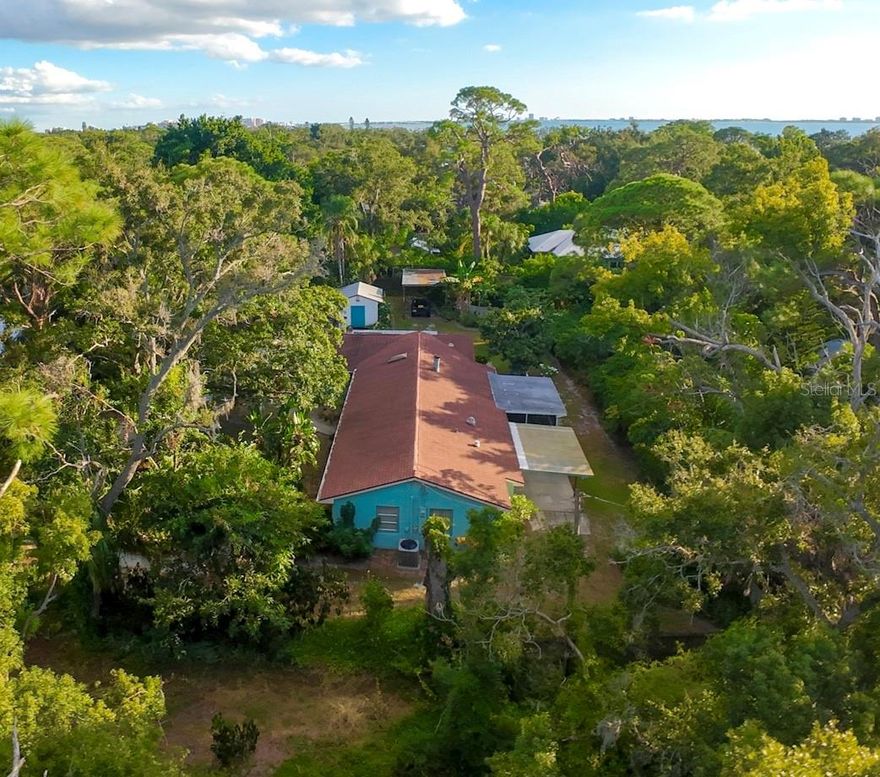 Nestled in a canopy of lush, tropical greenery in Indian Beach, this distinctive property captures the spirit of one of Sarasota’s most sought-after neighborhoods. A unique flag lot of over half an acre (25,378sf) with two separate driveways on different streets (front and back), this homesite represents an effortless blend of privacy, elegance, and accessibility, providing rare convenience and a true estate feel. An exceptional location just moments from iconic beaches, Sarasota Bay, Sapphire Shores Park, The Ringling Museum, Sarasota Jungle Gardens, SRQ Airport, and downtown Sarasota, this distinctive property affords a rare opportunity to reimagine the existing 1940's era homestead, or to create your own legacy home in a neighborhood that defines coastal sophistication.