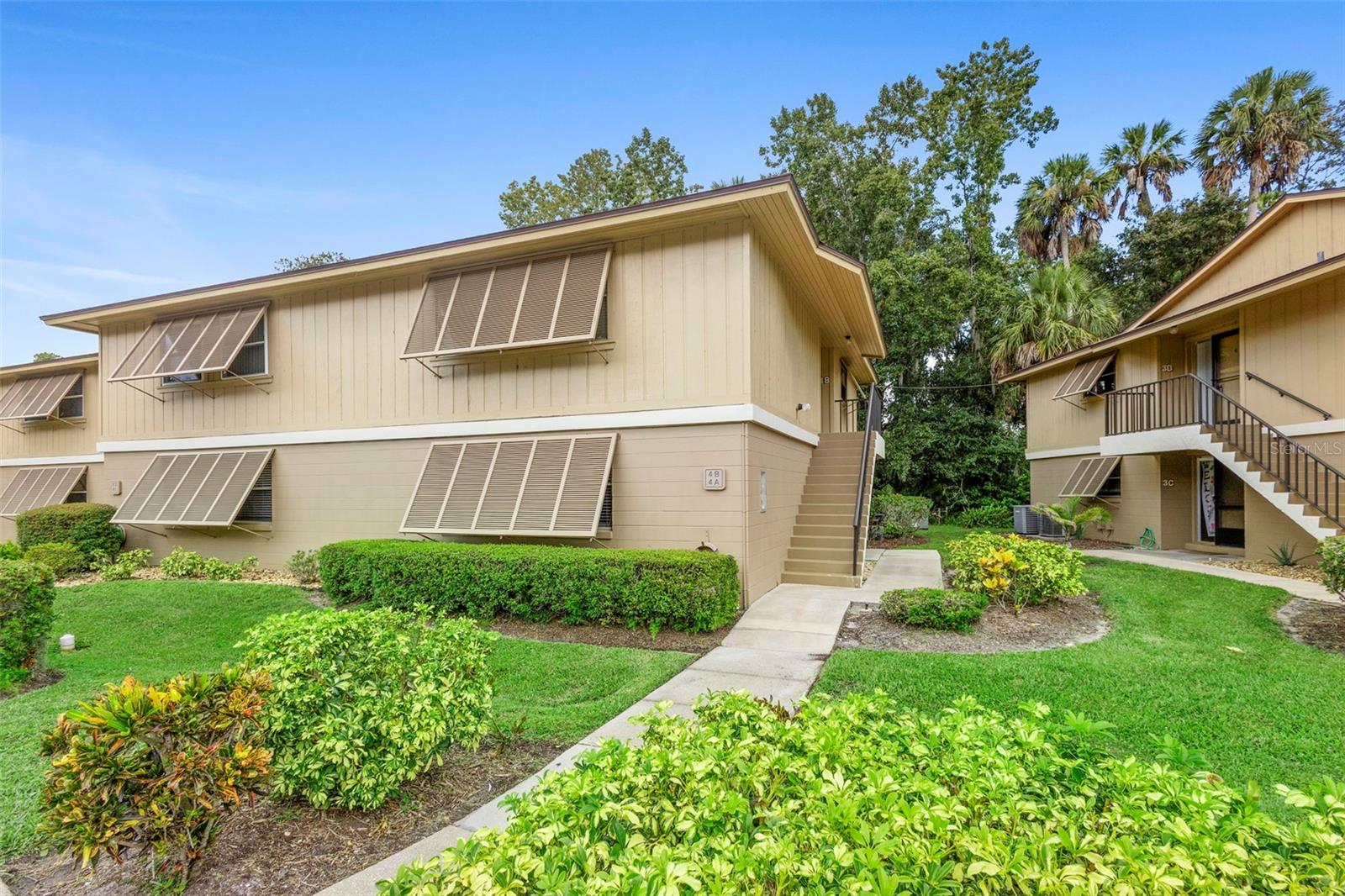 Nestled within the serene Lakeside Condominium community, this charming 2-bedroom, 2-bathroom residence offers 897 sq ft of comfortable living in a peaceful, park-like setting. Step inside to find cozy carpeting throughout, balanced by tile accents in kitchen, hallway and bathrooms.  The living and dining spaces flow seamlessly—ideal for entertaining or relaxing.  Outdoor enjoyment is at its best with a screened-in balcony overlooking lush landscaping—perfect for morning coffee or unwinding at day’s end.  Owner's suite includes bath with walk-in shower.  Lakeside Condominium residents enjoy excellent amenities—including a sparkling swimming pool and well-kept tennis courts - with easy access to the scenic walking and biking trail, Green Springs Park, and nearby Lake Monroe.  Location is a true highlight: mere minutes from I-4, public transit routes, SunRail station, Sanford/Orlando Airport, grocery stores, medical facilities, and nearby schools.  With a reasonable monthly HOA of $300, covering exterior and grounds maintenance, irrigation, reserves, and on-site management. This condo offers a worry-free lifestyle in a coveted Deltona neighborhood.  Enjoy peaceful, easy Florida living with endless amenities and strong connectivity. Don’t miss your chance—schedule a showing today!