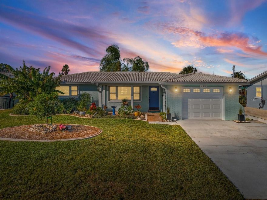 Looking for an affordable 2-bedroom single-family home in Hudson with Canal Access? Welcome to 12637 4th Isle — a fully remodeled waterfront retreat offering direct Gulf access, Stunning Sunsets, and thoughtfully updated finishes throughout. Perfect for Boaters, Fisher’s,  and Snowbirds. This 1,340-square-foot residence is situated on a 0.14-acre parcel and features a private dock, secure pilings prepared for a boat lift, and an enhanced seawall completed in 2022.The interior offers a newly renovated kitchen that is the true highlight of this home, featuring Custom Cherry Wood Cabinetry, Curava Savaii countertops made from recycled glass and seashells, beautiful light blue back splash, and brand-new appliances. From the kitchen, step into a spacious dining area ideal for gathering with family and friends-- then move out to the enclosed patio to take in the ocean breeze. The whole interior features warm coastal colors, giving the space a serene and welcoming feel, and both bathrooms have received impressive modern upgrades. Smartly designed custom closets in the bedrooms and pantry maximize storage throughout the home. Plenty of room for your king size bed in the primary bedroom. Natural light streams through the hurricane-rated windows, highlighting the gleaming refinished Terrazzo floors that extend effortlessly throughout the home. The exterior was freshly painted in 2025 and includes roll-down hurricane shutters, an upgraded garage door, and clean, low-maintenance landscaping.  You can enjoy the large, covered patio---perfect for outdoor dining, grilling, and watching the sunset over the canal. A fully fenced backyard offers added privacy and space for pets or entertainment, and the 1-car garage and wide driveway provide ample parking. Enjoy peaceful waterfront living with no HOA and low annual taxes—an ideal blend of value and beauty. Just minutes from Hudson Beach, Marinas, Waterfront restaurants, and Shopping makes it the ideal combination of comfort, access, of a Florida lifestyle. The minute you walk through the door, you will feel you are at home. Schedule your tour today!!