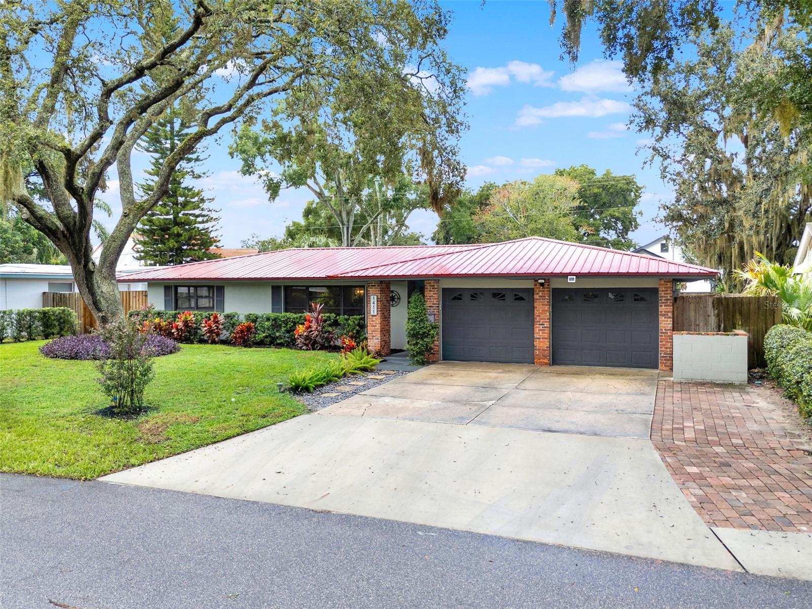 Welcome to 1411 Glastonberry Road, a spacious 5-bedroom, 2-bathroom home tucked within the desirable English Estates community in Maitland. This established neighborhood is known for its tree-lined streets, sense of community, and highly sought-after location within the top-rated Seminole County Public School System, making it an excellent choice for those looking for both comfort and convenience. Step inside and you will find a thoughtfully designed split floorplan that maximizes space and privacy. The home has been updated with laminate flooring throughout, providing a modern look that is both stylish and low-maintenance. The bathrooms have been tastefully renovated, giving a fresh and contemporary feel that complements the home’s overall design. Essential updates have already been taken care of for you, a durable metal roof provides peace of mind for years to come, a complete re-plumb in 2021. One of the most notable features is that the home has been converted to public sewer! The heart of the home features open living and dining areas that flow seamlessly, creating the perfect setting for both everyday living and entertaining. With five bedrooms, there is ample flexibility for a growing household, guests, or even creating a home office or hobby room to suit your lifestyle needs. Outdoors, the home continues to impress with a spacious fenced backyard that offers plenty of room to play, garden, or simply relax in privacy. Enjoy evenings on the covered patio, or step out to the additional brick paver patio, an ideal spot for hosting barbecues, gatherings, or simply soaking up Florida sunshine. Location is key, and this property delivers. You are just a short 10–15 minute drive to Park Avenue in Winter Park, where you can enjoy upscale dining, boutique shopping, and cultural attractions. Easy access to major roadways ensures quick commutes to Downtown Orlando, the Maitland Business District, and surrounding areas, making this home as practical as it is inviting.