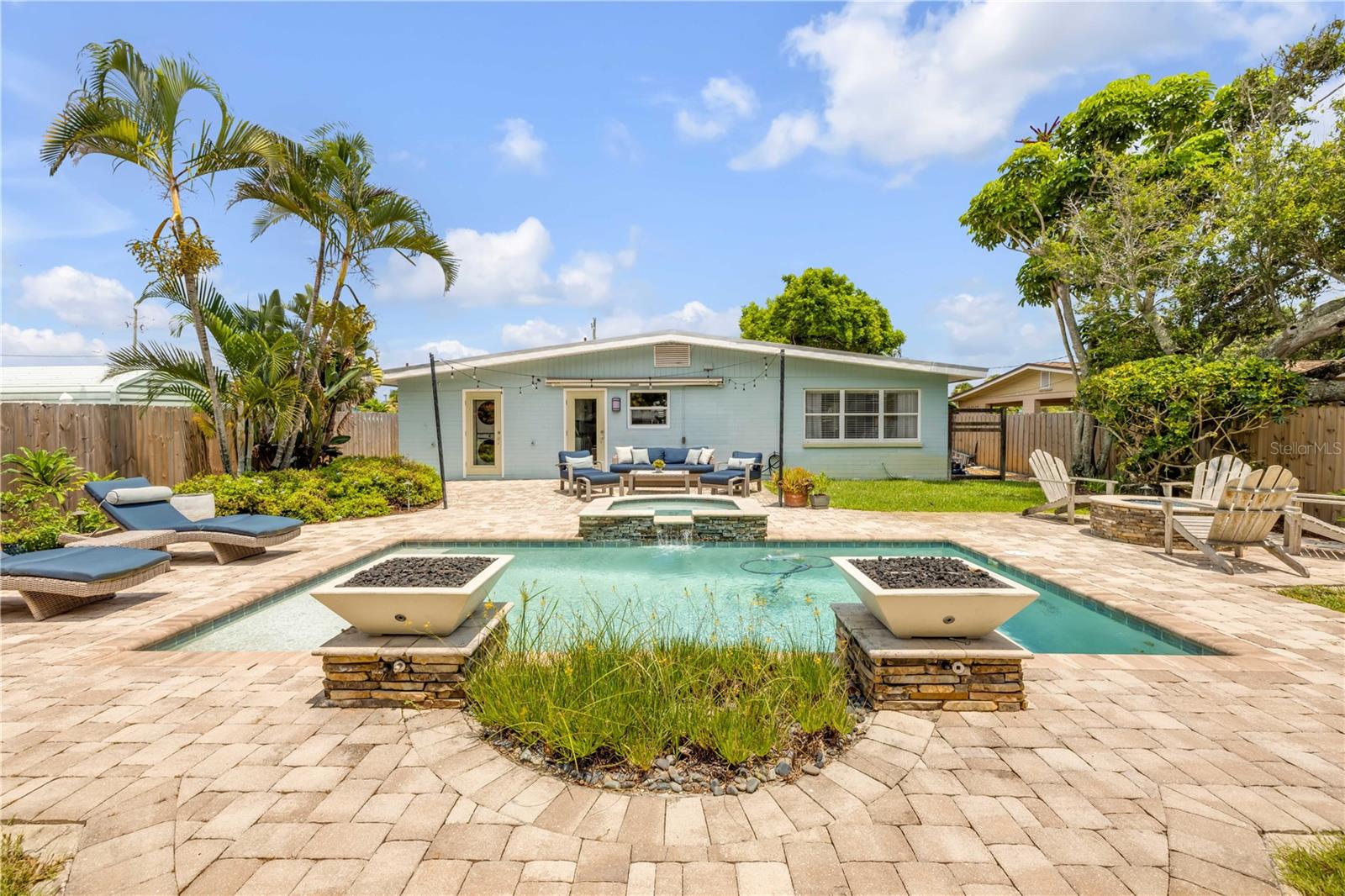 Move-in ready Beachside 3 bd, 2 ba, pool home. Just a few blocks to Flagler Avenue, one block to the beautiful beach. The fenced backyard has a salt water pool and spa surrounded by tropical mature landscaping, fire features, water fountain, fire pit, and roll out sun shade so you can enjoy the suns rays on cooler days and relief on warmer days. Fire pit, fire feature, gas grill and stove are all directly fed by the natural gas hookup. This stunningly remodeled home has terrazzo floors that have been restored meticulously retaining the beachside charm. Plantation shutters. Gorgeous kitchen with subway tile back splash, natural gas stove, granite counter tops, under counter lighting, stainless steel appliances, can lighting, all center around a beautiful custom blown glass light over the center kitchen island. Indoor laundry room with work area. Metal roof. 3/4 of the garage has been fully finished as an art studio which can be a home office or a 3rd bedroom. The remainder of the garage is could be used bikes, storage and yard equipment. Schedule your appt. today so you do not miss your opportunity to experience this home. Easy to show!