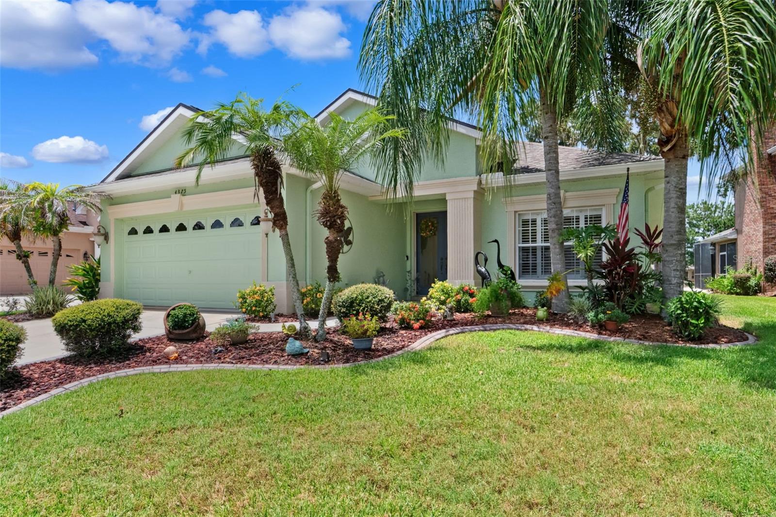 Welcome to this meticulously maintained 3-bedroom, 2-bathroom luxury pool home located in the prestigious gated golf community of Hernando Oaks in Brooksville, Florida. Perfectly situated on the signature par-5 8th hole tee box, this property offers breathtaking panoramic views of the sweeping fairway—creating a serene and picturesque backdrop that sets the tone for elegant Florida living. Inside, you'll find refined finishes and thoughtful upgrades throughout. The open-concept great room features custom tray ceilings, integrated recessed speakers for an enhanced surround sound experience, and 16 feet of sliding glass doors adorned with motorized blinds hidden beneath custom cornices—offering effortless access to the lanai and seamless indoor-outdoor living. LED lighting with dimmable switches has been installed throughout the home, casting a warm, customizable ambiance in every space. Southern-facing windows are tinted to prevent furniture fading and enhance energy efficiency. The crown molding adds a classic, cohesive touch throughout, while the custom tray ceilings in both the great room and primary suite elevate the architectural character. In the master bathroom, a spa-like rain shower with separate controls invites relaxation, while the two front guest bedrooms are connected by a convenient pass-through closet design. Additional smart home touches include updated motion-sensor bath exhaust fans, a motion-activated LED security floodlight at the front entry cove, and a decorative concrete driveway and walkway that enhance curb appeal. A brand-new roof installed in 2023 adds peace of mind and long-term value to this already exceptional property. The screened-in lanai and pool area offer an impressive outdoor retreat, designed under a special extended variance that allowed for an expanded cage and patio space. At the heart of this space is a custom-built entertainment center complete with a granite countertop, built-in refrigerator, 60-inch smart TV, stereo amplifier, hardwired Alexa system, and integrated speaker setup. The saltwater pool features LED underwater lighting with multi-color options and handheld remote, as well as a ''Solar Touch'' system that heats the water cost-free using discreetly mounted ''no see'' solar panels. The space is also pre-wired for a 50-amp, 220-volt hot tub, and highlighted with LED accent lighting on dimmer controls—perfect for evening entertaining or quiet relaxation. This exceptional home blends luxury, comfort, and lifestyle in one of Brooksville's most sought-after golf course communities. Whether you're enjoying sunrise views over the fairway or entertaining guests poolside under the stars, this home offers a rare opportunity to own a piece of Florida paradise. Come live the Florida Lifestyle You Deserve!