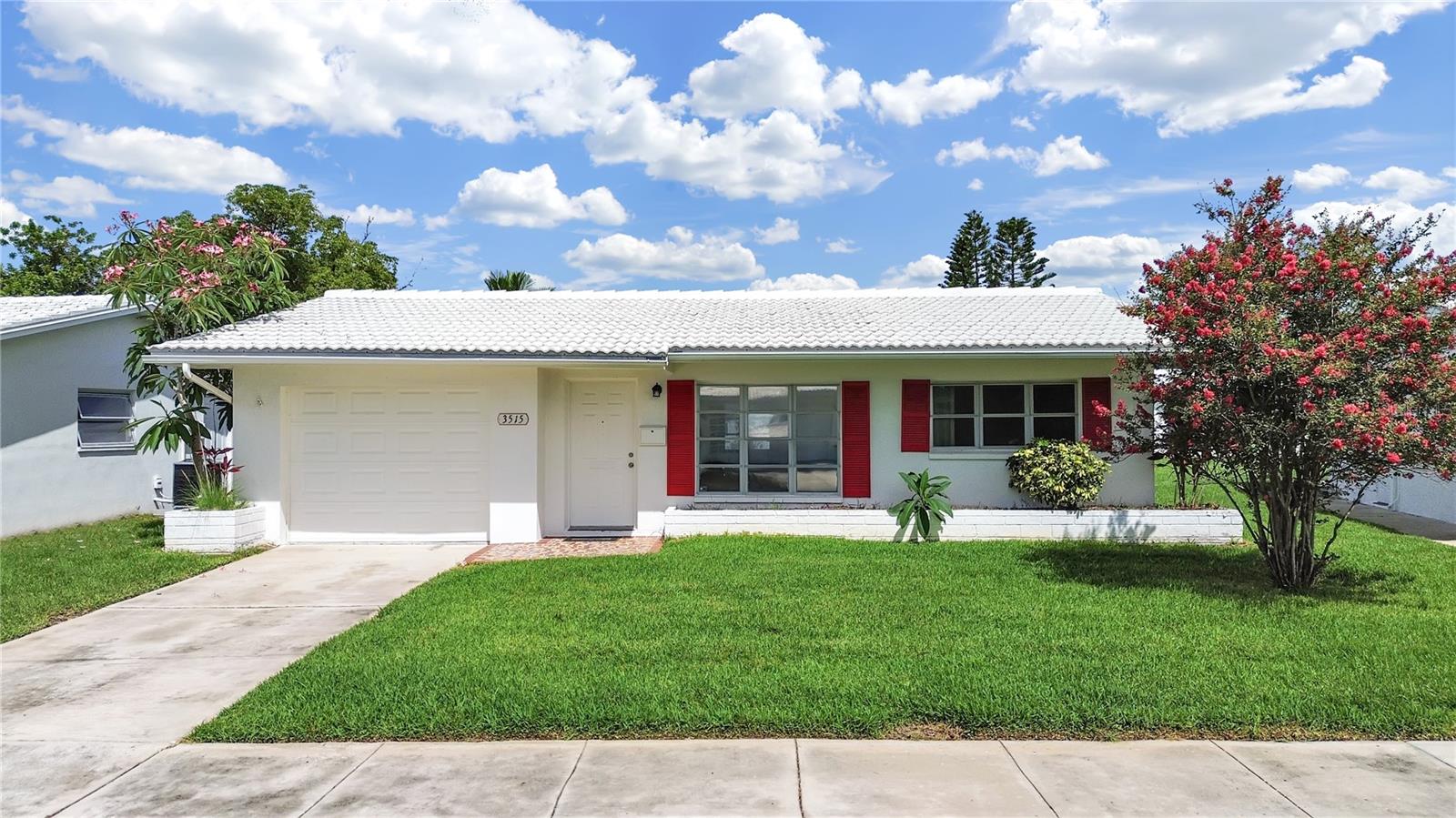 Welcome to your sunny Florida retreat! This charming, move-in ready block construction home is located in the highly sought-after Mainlands 55+ community. This home features a spacious open-concept living and dining area, perfect for relaxing or entertaining. The efficient kitchen is conveniently located to the left as you enter, and the large, light-filled Florida room at the back of the home offers additional living space to unwind and enjoy the peaceful views. Two comfortable bedrooms and a full bath are tucked away down the hall for privacy, and the attached one-car garage includes a washer and dryer for added convenience. Out back, a cozy patio overlooks tranquil green space—ideal for morning coffee or evening gatherings. Live worry-free with exterior maintenance and lawn care included in the monthly HOA fee. The Mainlands offers a vibrant lifestyle with access to clubhouses, seven community pools, a golf course, and a calendar full of fun activities including aqua fitness, chair yoga, book clubs, bingo, happy hours, and more. Centrally located just off US-19 with quick access to I-275, you’re just minutes from downtown St. Pete, Tampa, Dunedin, and Clearwater—and only 30 minutes to the beach! This home is clean, comfortable, and ready for immediate occupancy—schedule your tour today and start living the Florida dream!