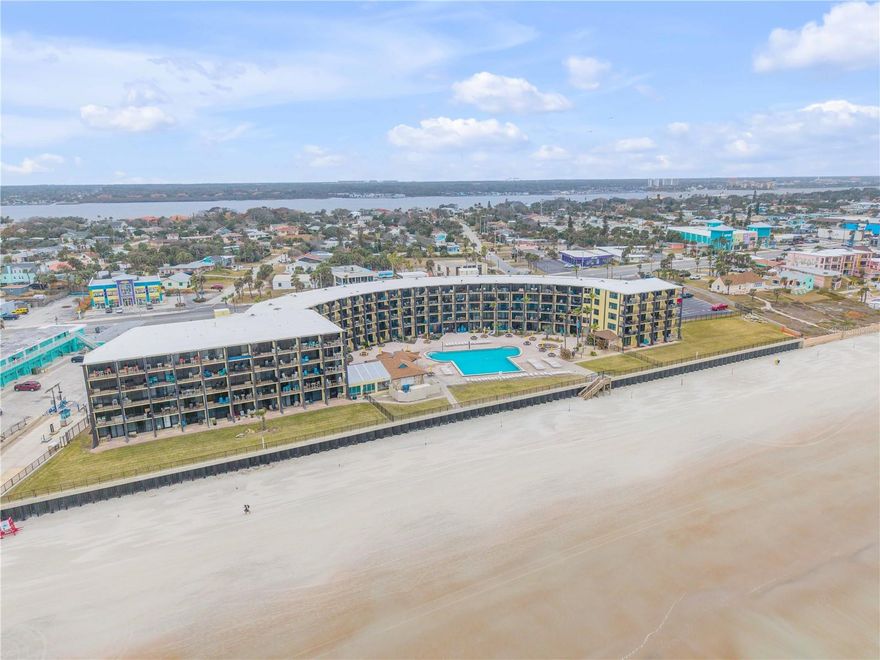 Experience true coastal living in this rare oceanfront studio condotel at the iconic Hawaiian Inn Beach Resort in Daytona Beach Shores. Perfectly positioned in the center of the building to maximize both ocean and pool views, this unit offers clear Atlantic vistas from an oversized private balcony—an uncommon feature for many properties in the area. Built in 1965, The Hawaiian is a classic mid-century modern, resort-style building that feels like a vacation destination year-round. This well-appointed studio features a clever, efficient layout with dedicated space for living, sleeping, and dining, all oriented toward bright ocean views. Step onto the expansive balcony to enjoy morning coffee with the sunrise or relax in the evening with coastal breezes over the Atlantic. The unit is currently part of the on-site rental pool, generating approximately $125–$175+ per night with professional management in place, offering excellent flexibility for personal use or investment. Residents and guests enjoy a true resort lifestyle with two sparkling pools (one heated), a seven-day-a-week tiki bar, direct beach access just steps from the building, on-site laundry facilities, a boutique beach store, arcade, and multiple amenities. An on-site restaurant is also set to relaunch following renovations. Whether you’re seeking a turnkey vacation home, a personal seaside retreat, or a rental property with proven income potential, this oceanfront studio delivers both lifestyle and cash-flow opportunity in one of Daytona’s most classic beachfront settings.