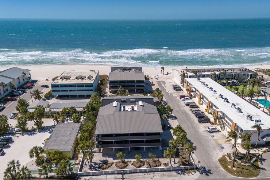 Successful rental Property. Exclusive gulf-front living in Holmes Beach. On the pristine shores of Anna Maria Island, this exquisite corner-unit condominium offers an unparalleled blend of luxury, privacy, and breathtaking gulf views. In an exclusive 16-residence community, with only eight units in each building, this intimate complex is positioned between a sparkling heated pool and the powdery sands of the beach. Designed for tranquility and convenience, this two-bedroom, two-bath retreat boasts expansive windows that flood the space with natural light, accentuating the sweeping coastal vistas. The open-concept kitchen, complete with a central cooking island, seamlessly flows into the dining and living areas, creating an inviting space for entertaining. A rare find, this corner unit ensures maximum privacy, while spacious closets and an in-unit laundry enhance everyday comfort. With a 30-day minimum rental policy, the community maintains an exclusive, low-turnover atmosphere, ideal for those seeking a more serene coastal escape. Covered parking under the building adds convenience, and a shaded barbecue area by the pool provides a picturesque setting for outdoor gatherings. Ideally located, this residence offers effortless access to the charming shops, acclaimed dining, and vibrant culture of Holmes Beach and Anna Maria Island. Experience gulf-front living at its finest, where tranquility, luxury and convenience converge. Schedule your private showing today.