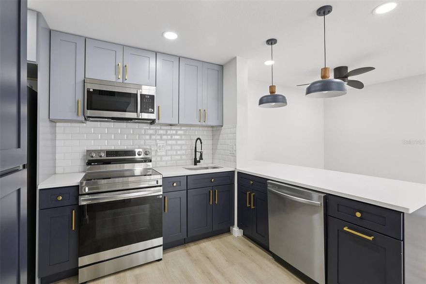 Fully remodeled and move-in ready, this 2-bedroom, 2-bath condo in Pine Ridge at Lake Tarpon Village delivers 979 square feet of modern, turnkey living. New LVP flooring and a fresh interior paint job set the tone throughout, complemented by updated light fixtures and high-end hardware that create a cohesive space. The kitchen is brand new with shaker cabinetry, quartz countertops, stainless steel appliances, and a subway tile backsplash. In the primary suite, the private en-suite features a spacious walk-in shower, tiled floor to ceiling with a contemporary waterfall rain head and hand shower. The huge walk-in closet also offers plenty of space for storage. The guest bath has been fully updated to match. Practical details are covered too, the unit includes an in-unit washer and dryer closet and a brand new HVAC system installed in 2025. The building is tucked at the back of the community overlooking a peaceful natural preserve, giving you privacy and views without leaving the neighborhood. HOA covers water, sewer, trash, escrow reserves, building exterior maintenance, and access to the community clubhouse, pool, and tennis courts. All of this in the heart of the East Lake corridor, minutes from top-rated schools, shopping, dining, and major commuter routes. Call today to schedule your private showing.