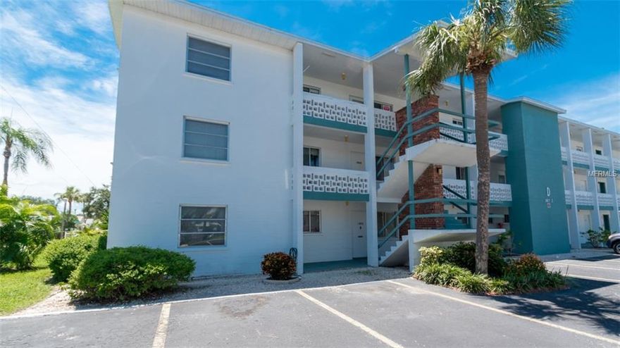 Your condo is situated on the second floor in the 55 plus community of Bayshore Gardens.  Walking into your condo you are immediately invited into an open floor concept featuring the dining space and living area. To the right of the front door is your kitchen fully stocked with all amenities you could need while on vacation. Enjoy seating at the breakfast nook in the morning with a nice cup of coffee.

Walking back out of the kitchen you have your dining area that comfortably seats 4.  The living room area is warm and cozy and boasts plenty of Florida sunshine. With plenty of seating and a large flat screen TV this is the ultimate place to kick back and relax. Through the sliding glass doors is a lanai and seating, a perfect spot to unwind and enjoy the scenery after a long days’ worth of fun activities.