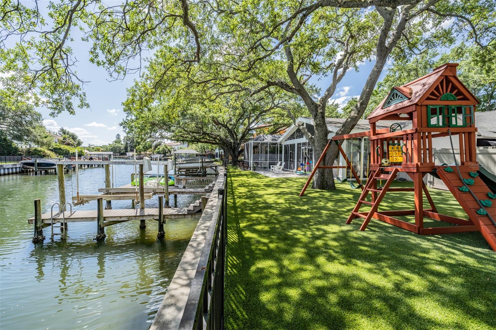 Discover this rare gem among the remaining original Davis Islands homes—a beautifully updated and impeccably maintained waterfront pool home. With 2,579 square feet of living space, this one-of-a-kind property showcases custom designer finishes throughout, creating a perfect blend of classic charm and modern luxury. All situated on a 1/4 acre waterfront lot!
Step inside to find three spacious bedrooms and three and a half bathrooms, as well as gleaming hardwood floors that flow seamlessly throughout the house. The gourmet kitchen, complete with top-of-the-line appliances and fixtures, caters to all your culinary needs. With both formal and informal living and dining spaces, this home is perfect for hosting intimate gatherings or grand celebrations.
French doors open to reveal an expansive, screened-in lanai and pool/spa area, offering the perfect setting for relaxation or outdoor entertaining. Beyond the pool, you'll find a large, fully fenced backyard boasting over 100 feet of water frontage. Mature live oaks provide ample shade, while artificial turf ensures a safe and low-maintenance space for outdoor activities and play. *Seawall, dock, and lift were fully replaced a few years ago.
Boating enthusiasts will appreciate the convenience of a composite dock and boat lift, allowing you to effortlessly launch your boat and enjoy picturesque sunsets on the bay. Nestled in the prestigious Davis Islands community, this waterfront pool home offers the ultimate in comfort, style, and waterfront living. Don't miss the opportunity to make this extraordinary residence your very own!
**FOR BOATS: Depending on tide height, clearance under the bridge will roughly vary between 4' to 6' from top of the water to bottom side of the bridge for access to the Bay. At the end of the photo gallery are some examples of different boats going under the bridge.** **Owners pay $3,900 a year for flood insurance**