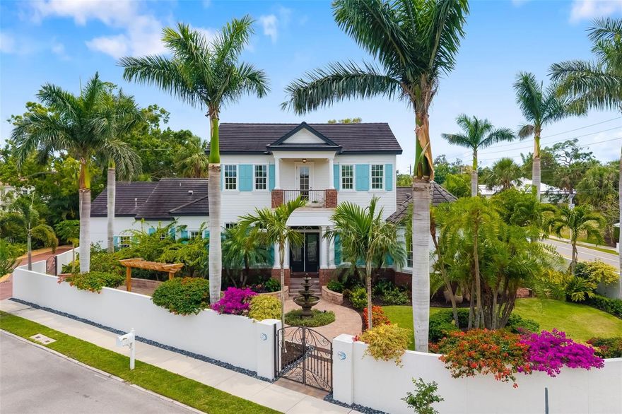 Discover a rare blend of architectural integrity, walkable convenience and low-maintenance privacy in Sarasota’s coveted West of Trail neighborhood, Avondale, just moments from downtown, Bayfront Park and Southside Village. Situated on a corner lot for easy access yet engineered for peace, this solid block-constructed home with impact-rated windows, a privacy wall and exceptional sound insulation lives remarkably quiet once inside the gates. Professionally designed landscaping and elegant landscape lighting create a welcoming ambiance both day and night. The layout is ideal for single-level living, with the primary suite, main gathering areas, and a designated private office all on the ground floor, while upstairs offers ensuite guest rooms and flexible bonus space for visiting family, hobbies or fitness needs. Designed for serious cooks and relaxed entertainers, the chef’s kitchen features Sub-Zero, Wolf, Thermador, and Bosch appliances, custom cabinetry and a generous island, complemented by a dedicated bar area and a temperature-controlled 450-bottle wine cellar. Sliding doors open to an outdoor living area built for year-round enjoyment, including a heated saltwater pool enhanced by the soothing sound of a cascading waterfall, a screened lanai and a fully equipped summer kitchen with a granite bar. Additional features include a Kohler whole-house generator, tankless gas water heater, a three-car side-entry garage with storage and epoxy flooring, and full property enclosure for security and ease of lock-and-leave living. For those seeking location without compromise, privacy without isolation and luxury without upkeep, this Avondale residence delivers the best of Sarasota living in one exceptional package.