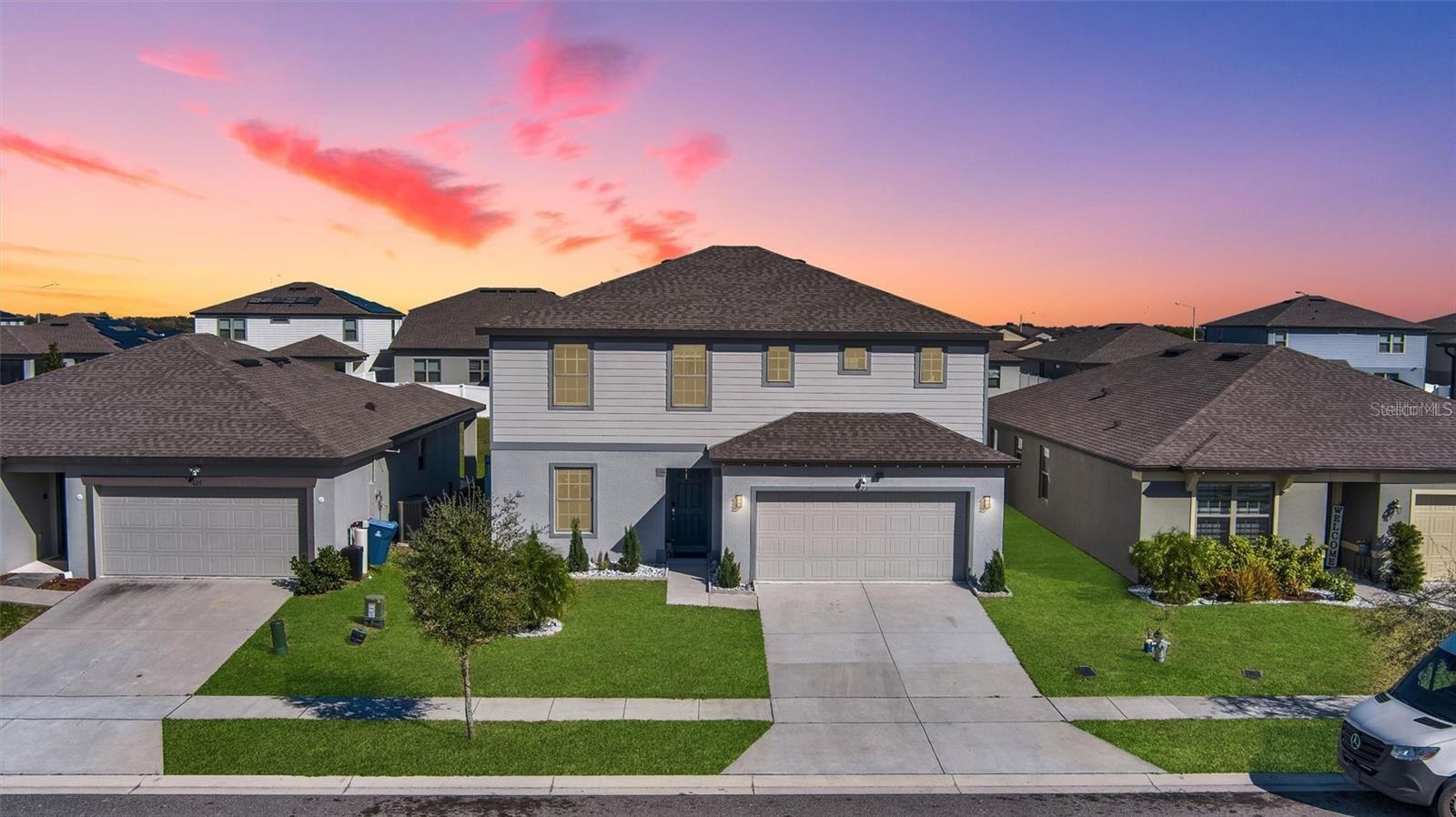 This stunning 4-bedroom, 2.5-bath home, built in 2021, combines modern design with luxurious finishes. The open-concept floor plan flows seamlessly throughout the first floor, highlighted by 24x24 porcelain tile with a sleek marble look. The gourmet kitchen showcases wood cabinetry, a striking Calacatta quartz waterfall-edge island, and elegant quartz countertops carried into the bathrooms. The master suite offers a spacious custom walk-in closet, creating the perfect retreat.
Step outside to a private fenced backyard—ideal for a future pool—complete with a paved lanai for relaxation or entertaining. Additional features include energy-efficient windows, a sprinkler system, security cameras, and surround sound speakers in the living area. Conveniently located near top restaurants, world-famous theme parks, and premier outlet shopping, this home delivers both comfort and style in the heart of Central Florida living.