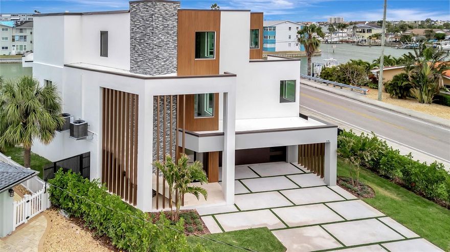 Newly Completed. Modern Waterfront Luxury Estate in Pasadena Isles. Discover this extraordinary modern European-style masterpiece by Everstone Development. This stunning elevated two-story waterfront estate features 5 bedrooms, 4 full bathrooms + 2 half bathrooms, and over 4,000 sf of living space. Boasting direct frontage on the Intracoastal Waterway (Boca Ciega Bay), the home offers breathtaking water views and effortless coastal living, just a 5-minute drive from the beach. Wake to the gentle sounds of the water, enjoy effortless days of boating and water sports, and end each evening with spectacular golden sunsets from your own backyard oasis. The expansive open-concept design seamlessly blends indoor and outdoor living with 80 feet of dramatic floor-to-ceiling glass that frames sweeping views of the sparkling pool and serene waterway beyond. Step outside to the expansive 40-foot covered lanai, perfect for year-round alfresco dining and entertaining while soaking in the sunset views. The property includes a large private dock, ready for your boat lift to be installed, ideal for a quick access to some of the area’s best fishing spots. Additional highlights include: A state-of-the-art elevator for effortless access to all levels, a 4-tandem car garage with ample room for vehicles, water toys, beach gear, or a hobby workshop and a private media room. The expansive outdoor living area is a true showstopper, featuring an oversized patio with abundant open space perfect for launching kayaks or paddleboards, hosting lively gatherings, or simply unwinding in style. At the heart of the space sits an outdoor kitchen complete with a built-in grill, offering the ultimate convenience for a dining and entertaining.  Whether you're hosting sunset cocktail parties, family barbecues, or relaxed waterfront dinners, this generous area seamlessly blends luxury and functionality. Every vantage point delivers stunning waterfront views across the sparkling pool to the serene Intracoastal Waterway beyond, creating an inviting backdrop that makes every moment feel like a private resort escape.
Thoughtful design that prioritizes both luxury and functionality for today’s modern lifestyle.
Located just 20 minutes from vibrant downtown St. Petersburg, you’ll enjoy easy access to world-class dining, shopping, cultural attractions, and the iconic St. Pete Pier. This is more than a home — it’s a private waterfront sanctuary where every day feels like a vacation.