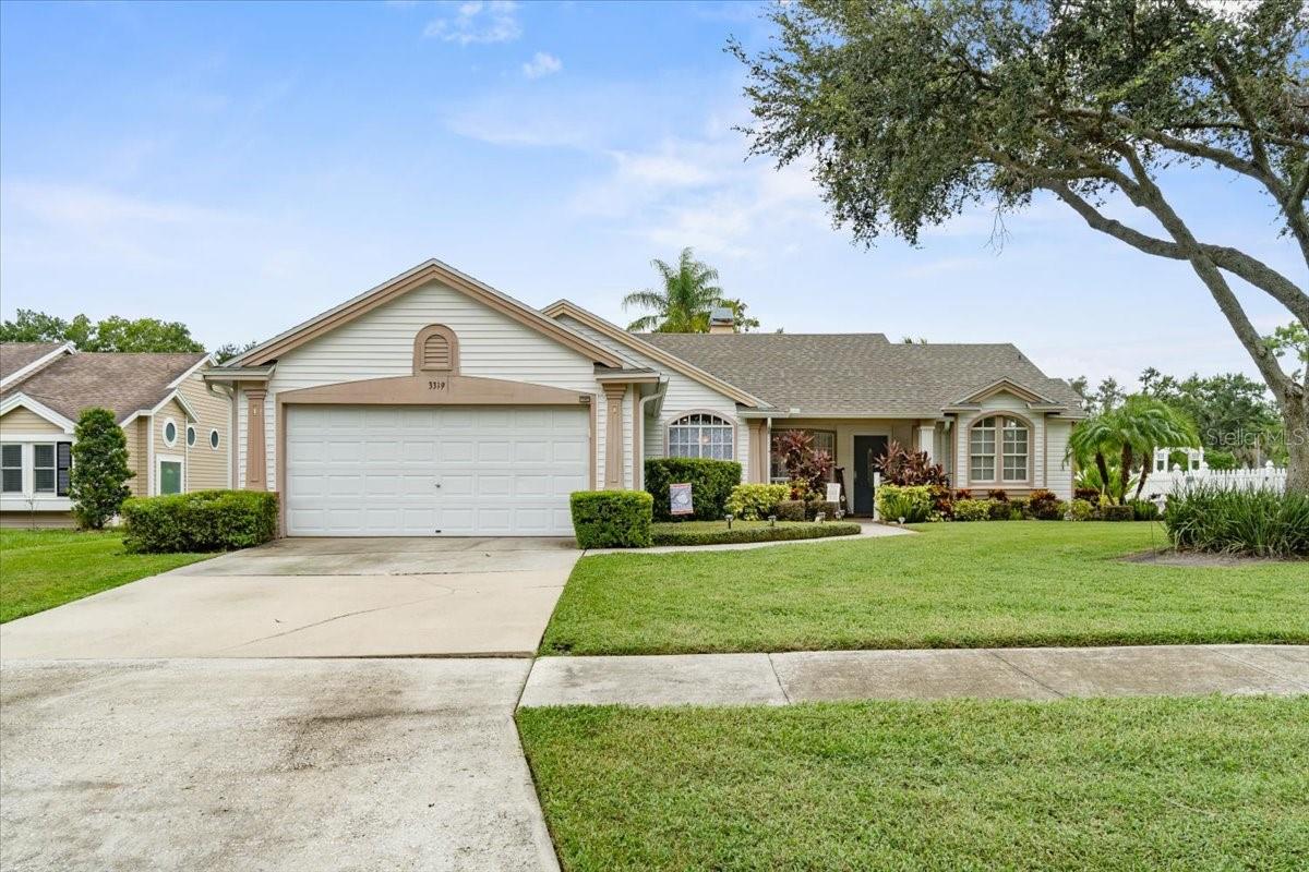 Curb appeal indeed! Don't miss this clean and cozy four bed, two bath home with pond and sunset views. Upon arrival, you'll fall in love with the tidy front yard and beautiful walk to the front door. As you enter the home, the warm living room with double sided fireplace welcomes you in to relax and enjoy. The master bedroom and updated en suite bath are complimented by an oversized walk-in closet. The kitchen overlooks the large family room and shared fireplace. A generous split plan has the additional three bedrooms and pool bath located off the family room. You'll want to enjoy many afternoons cooling off in the pool and evenings enjoying the sunset from the screened lanai. You have the added benefits of a brand-new roof as of 4/25, new HVAC duct work, and the house was re-plumbed 6 years ago.