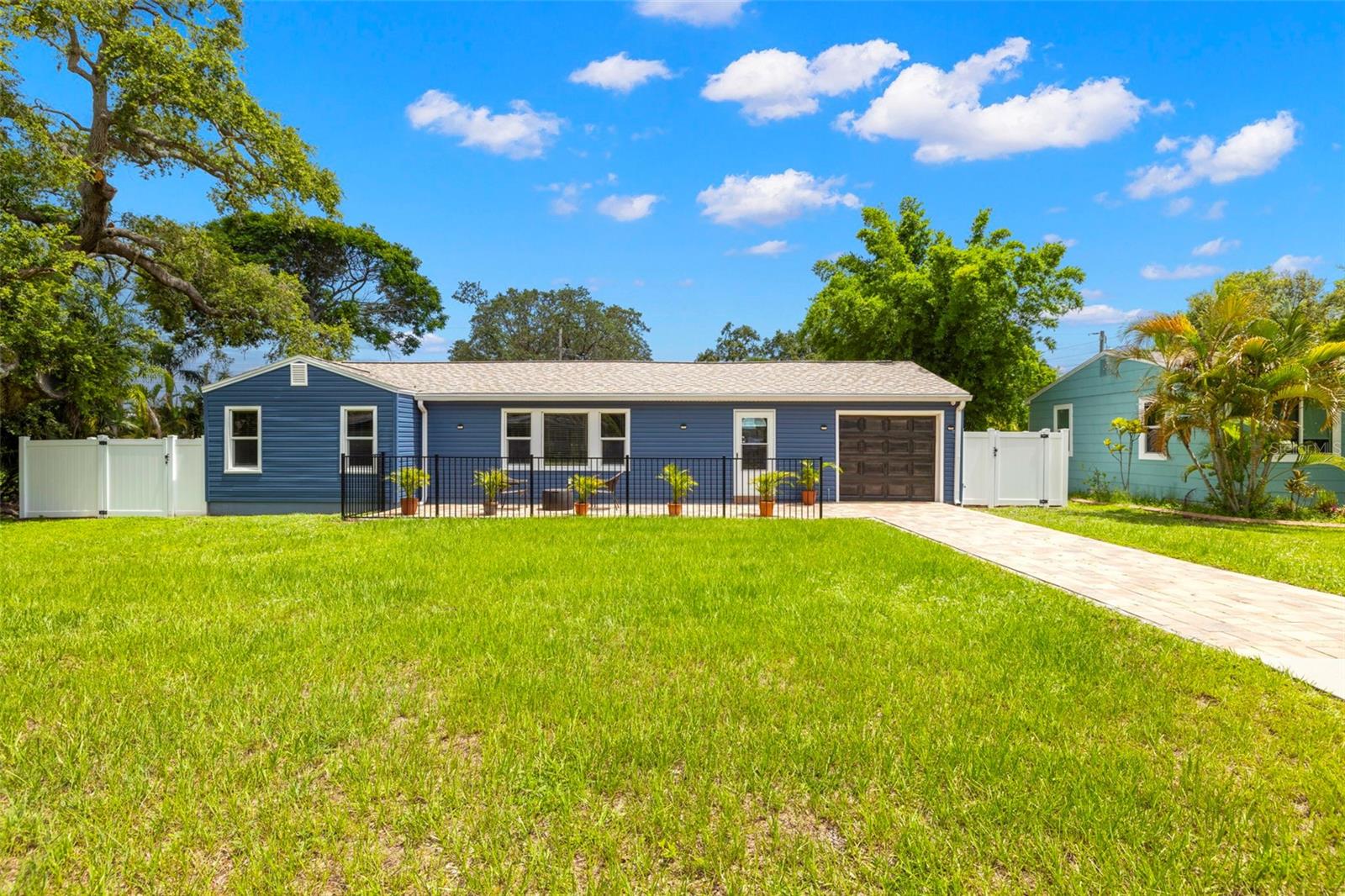 This meticulously maintained 2-bedroom, 1-bath home with a 1-car garage and two spacious bonus rooms offers both style and substance in desirable South Dunedin. Set on a generously sized lot with exceptional space for a future backyard retreat or pool, the property features a newer roof (2023), custom siding (2019), and a paver driveway that flows beautifully into a spacious, matching front patio, creating a cohesive and visually appealing outdoor welcome. Greeting you upon entry, classic terrazzo flooring and original wood paneling add mid-century character, while the bright tiled main living area is elevated by custom-installed louvers and an effortless layout. A gas-connected kitchen caters to culinary enthusiasts, and two sets of French doors open to an impressive 27x11 Florida room (not reflected in base sq ft) with walls of windows that invite natural light and create a seamless connection to the beautifully sized backyard. The fenced yard includes a wide gate for convenient access and endless possibilities for outdoor living or entertaining. Located in a well-established neighborhood just a mile from downtown Dunedin, and within blocks of the Pinellas Trail and Edgewater Drive’s scenic shoreline, this property offers a rare blend of character, flexibility, and convenience in one of the area’s most beloved communities. No flood insurance required zone. Contact us to arrange your private showing and experience all this home has to offer.