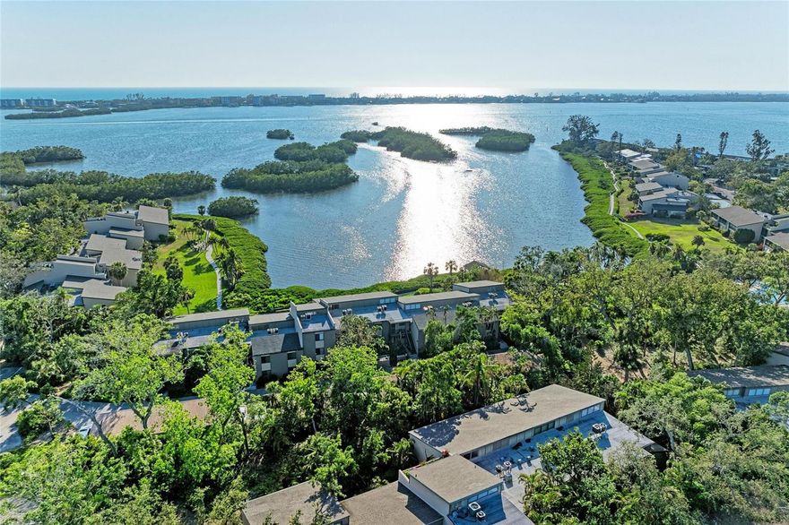 WELCOME HOME To The Highly Sought After BAYHOUSES SECTION Within PELICAN COVE - FULL BAY VIEWS | 3 Bed / 3 Bath | First Floor End Unit --- Welcome to Pelican Cove, a hidden gem located west of US-41 in South Sarasota. This rarely available 3-bedroom, 3-bath first-floor end unit offers sweeping, unobstructed views of the bay—visible from nearly every room! With porcelain tile throughout, this spacious condo features a smart split-bedroom layout for privacy and comfort. -- The primary suite is a retreat of its own with volume ceilings, a walk-in closet, a cozy sitting area, an en suite bath with a newly remodeled walk-in shower, and even a private outdoor patio—all overlooking the bay. One of the guest bedrooms includes a private bath and its own entrance to the lanai—making it an ideal setup for guests or an In-Law Suite. -- The fully enclosed lanai extends your living space and offers an incredible front-row seat to the water. The kitchen has been fully renovated with a open layout—walls have been removed to create a seamless connection to the dining and living areas, maximizing both space and views. Sold partially furnished and move-in ready, nothing needs to be done. -- Step outside and enjoy the serene observation deck just steps from your door—perfect for daily sunsets over the water. Pelican Cove is a 75-acre gated community rich with amenities: 86-slip boat harbor, 6 heated pools + hot tub, 3 clubhouses, Tennis & pickleball courts, Fitness center, Walking trails, boardwalks & bird sanctuary, Kayak launch, fishing gazebo, Art studios, Pelican Cove University & 30+ clubs... -- This Is More Than A Condo—It’s A Lifestyle. Come see why Pelican Cove is one of Sarasota’s most sought-after waterfront communities.