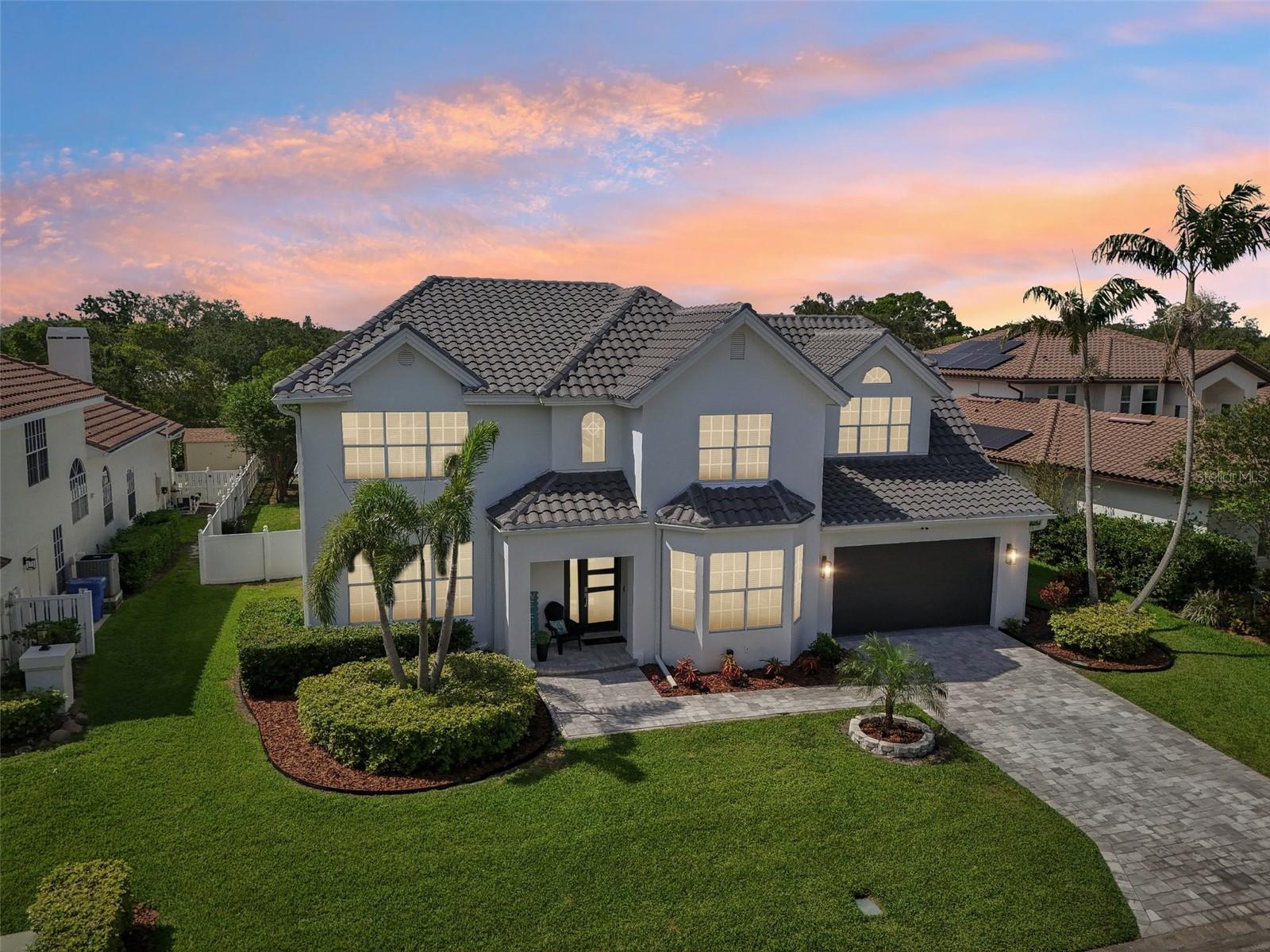 High and dry, never flooded! Welcome to a rare offering in the exclusive gated waterfront community of Placido Bayou in St. Petersburg! This newly renovated waterfront 6-bed, 4.5-bath, 2-car garage pool home offers nearly 4,000 square feet of bright, elegant living space, featuring high-end finishes and thoughtful design throughout. A brand-new tile roof (2023) crowns the home, while an abundance of natural light fills every corner. A grand entryway with a dramatic staircase and a stunning chandelier sets the tone for this impressive home. With two spacious master suites—one on each level—this home is perfect for multi-generational living or providing ultimate comfort and privacy for guests. The downstairs suite opens to the pool deck through two sets of French doors and features a spa-inspired bath with dual sinks, a frameless glass shower, and a separate soaking tub. The upstairs suite boasts a custom walk-in shower, free-standing tub, dual vanities, and a generous walk-in closet. Create chef-inspired meals in a kitchen with ample cabinetry, prep areas, breakfast bar, and casual dining nook. Entertain effortlessly with a custom dry bar complete with a 2-drawer stainless drink fridge. A formal living area features pocket glass sliders that open completely to a screened-in, resort-style pool and patio, while a separate family room provides additional gathering space. Glass sliding doors in the dining room invite seamless indoor-outdoor living. Convenience abounds with laundry rooms on both floors. Enjoy a custom saltwater lap pool with spa, LED lighting, tranquil waterfall, playful bubbler, and built-in seating (2020). The outdoor oasis is complete with a half basketball court and waterfront access to Tampa Bay via a newer dock (2019) with two boat lifts. All of this is just minutes from downtown St. Pete, I-275, top dining, shopping, and only 25 minutes to Tampa!