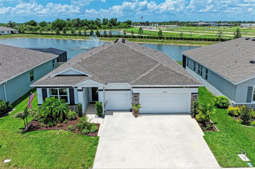 One or more photo(s) has been virtually staged. Located in the desirable community of Bella Lago, this stunning 4 bedroom, 3.5 bathroom home with an office and saltwater pool offers the perfect blend of luxury, comfort, and functionality. Curb appeal abounds with beautiful landscaping, stone facing, and a 3-car garage. Step inside and immediately notice the light and bright open feel, enhanced by tile flooring throughout the main living areas. Thoughtful upgrades include tray ceilings, shiplap, and custom trim & woodwork accents throughout the home. This highly desirable floorplan features a rare double master suite layout, perfect for out-of-town guests or anyone wanting additional privacy. The chef’s kitchen is sure to impress with quartz countertops, tile backsplash, stainless steel appliances, a large center island, and cabinets with crown molding. The kitchen opens seamlessly to the spacious great room, creating the ideal setup for entertaining. A formal dining room and separate eat-in space provide plenty of dining options for everyday living and special occasions. The spacious primary suite features a large walk-in closet and an ensuite bathroom complete with dual sinks, a garden tub, and a walk-in tiled shower. Additional conveniences include a laundry room with cabinetry and wash bin, along with a mudroom/drop zone just off the garage. The garage itself has been upgraded with epoxy flooring. Step outside to your private backyard oasis featuring a saltwater pool with electric heater and chiller, a fully fenced yard, and expansive pond views with a fountain. Additional features include cameras, gutters, hurricane shutters, and an irrigation system. Bella Lago community offers a range of excellent amenities, including a pool, a fully equipped gym, a playground, dog park and plenty of green space to enjoy. Whether you want to stay active or simply relax, there’s something for everyone in this wonderful community. Parrish is ideally located near major areas like Lakewood Ranch, Sarasota, St. Petersburg, and Tampa. You’re also a short drive to beautiful beaches and the Ellenton Premium Outlet Mall, shopping centers, restaurants, and essential stores just minutes away, with even more amenities on the horizon as the area continues to grow. This home offers the perfect combination of modern living, serene pond views, and an unbeatable location. Schedule a showing today and make this exceptional home yours!