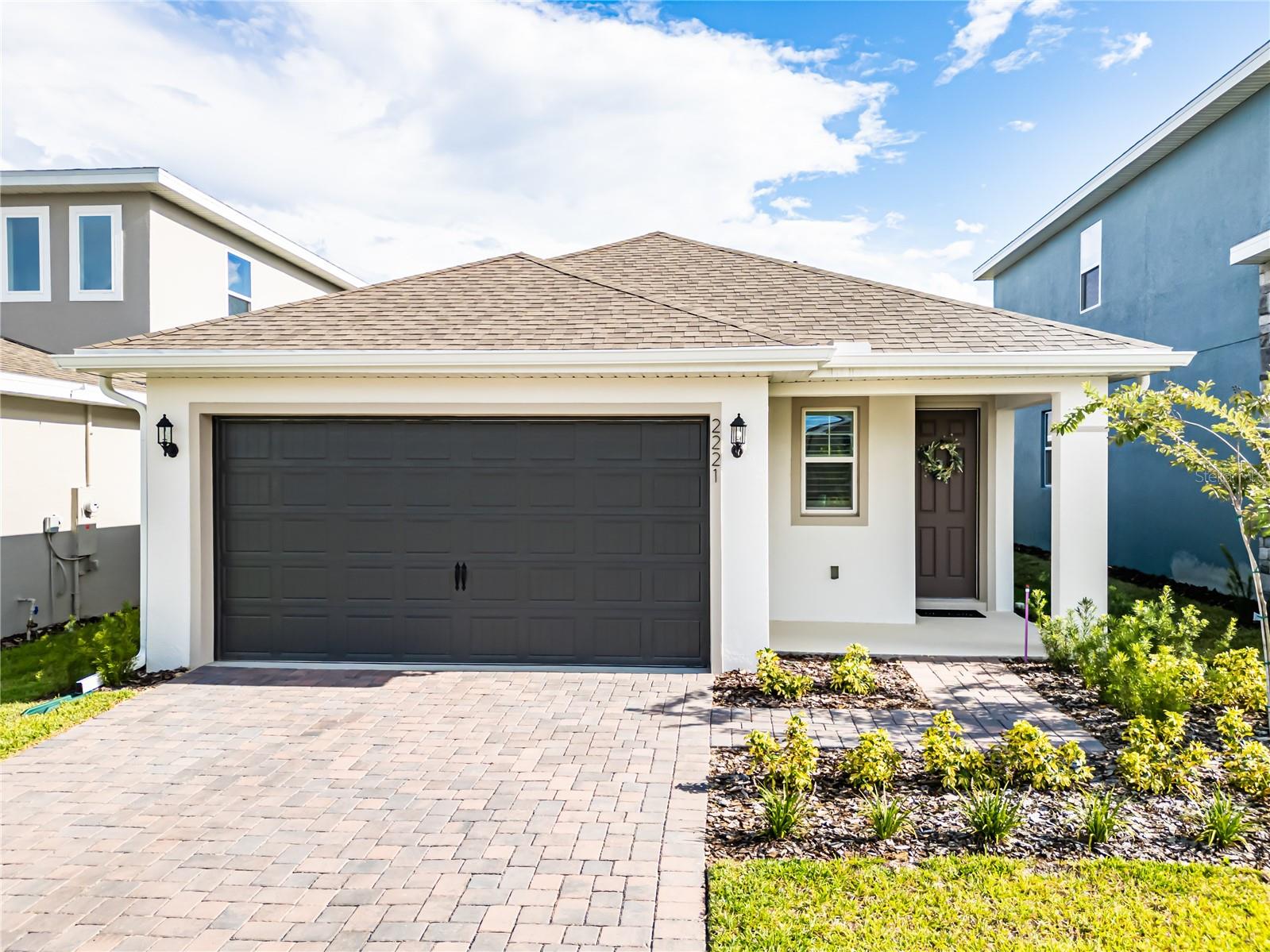 Start your new chapter with a FREE GOLF CART included with this home purchase! This practically new, 4-bedroom, 2-bath home built in 2025 is filled with upgrades you'll love!
Inside, you'll find elegant wood-plank tile flooring throughout the entire home, combining the classic warmth of a wood look with the durability and easy maintenance of tile. The open concept flows well with an abundance of windows pouring in tons of natural light. The modern kitchen is going to be a show stopper!! You'll love the beautiful white on white countertops and cabinets with the upgraded black light fixtures to give it a pop! All the bedrooms are spacious! The versatile modern Murphy bed allows you to transform a bedroom into a functional office or workout space in an instant. The home also features stylish and energy-efficient plantation shutters that provide excellent light control and privacy. All appliances, including the refrigerator, washer, and dryer, are included, and new light fixtures have been installed to complete the modern look.
Outside, enjoy the Florida lifestyle from your screened-in lanai, offering a bug-free space to relax and entertain. The seamless gutters protect your home's foundation and landscaping from water damage. Location is everything, and this home delivers. You'll be within walking distance of the brand new Minneola Horizon Academy K-8 school and right across the street from the new hospital and Crooked Can Brewery & food hall. Best of all, you'll be able to drive your new golf cart to all the exciting things going on in and around the community! As an added bonus, this home comes with a transferable FULL BUILDER WARRANTY that is good through March 2026, as well as a 10-year structural warranty, giving you peace of mind with your purchase. Come see this home today to get everything you want and more at a great price!