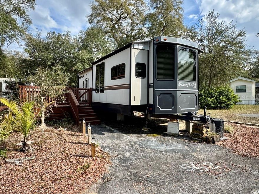 A 2017 Fairfield RV with a 14x22 open deck is situated on lot #52(3,049sqft) in the Salt Springs Resort. The unit has a new refrigerator, gas range, pantry, island with double sink, new queen mattress, bathroom w/ walk-in shower, and a storage building with washer and dryer. All furniture to remain with unit. The resort offers a clubhouse, two pools, hot tub, tennis courts, dog park, dock & boat ramp to Little Lake Kerr. Walking distance to restaurants, shopping, and the springs. Perfect for weekends or full-time residence. The HOA fee is $706 a quarter. Salt Springs is a nice, quaint area located in the Ocala National Forest.