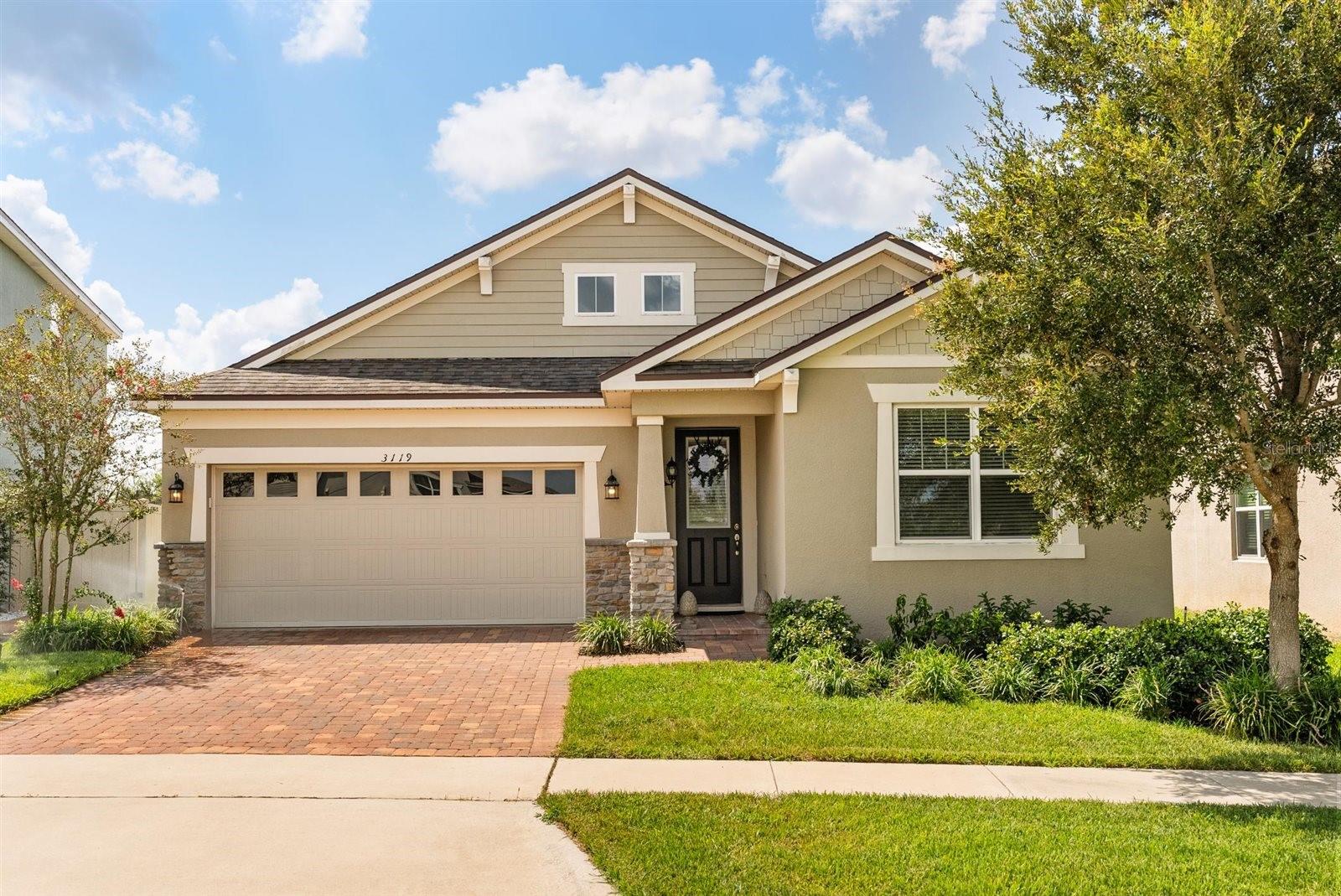 Nestled in the vibrant Waterbrooke Community of Clermont, this lovingly maintained single-level home offers 1,842 sq ft of refined living space with 3 bedrooms, 2 baths, and a covered two-car garage. From the moment you arrive, the paver-lined driveway and thoughtful exterior touches set the tone for quality and curb appeal. Inside, the high 9-ft ceilings, tray ceiling in the master suite, and open-concept layout create an airy, light-filled atmosphere that flows seamlessly through the living, dining, and kitchen areas. The kitchen is appointed with Timberlake cabinetry, granite countertops, stainless appliances including a stainless side-by-side refrigerator, and a bar-height island perfect for entertaining. Upgraded ceramic tile flooring in calming gray-taupe hues runs throughout the main living areas, while plush carpeting in the secondary bedrooms strikes a perfect balance of style and comfort. A standout feature is the screened porch with paver flooring, offering an ideal space for al fresco evenings and Florida-style relaxation. The home’s double insulation and hurricane ties ensure lasting energy efficiency, comfort, and peace of mind, while the well-maintained AC with UV light adds another level of assurance. Practical upgrades like ceiling fans, chic fixtures, a Kichler modern craftsman chandelier, elegant draperies with decorator rods, and blinds are all included, along with a washer and dryer for ultimate convenience. The option to purchase high-quality furnishings provides a seamless move-in experience. Impeccably cleaned and curated with meticulous attention to detail, this home truly reflects pride of ownership. Situated on an 6,835 sq ft lot within a friendly neighborhood, you’re just moments away from shopping, dining, top schools, and Central Florida’s renowned attractions—making this home a beautiful blend of convenience, comfort, and style.