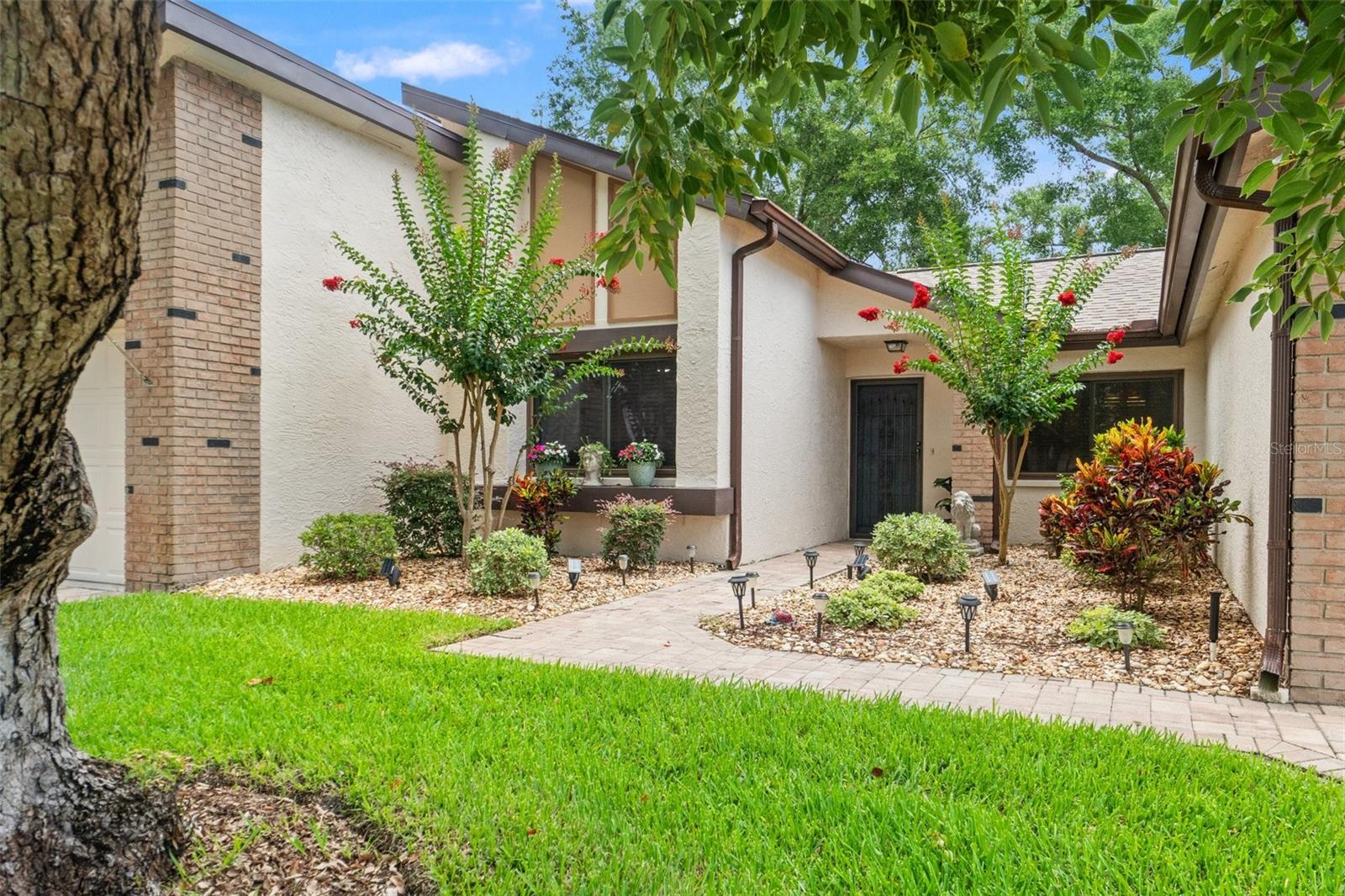 LAKE-VIEW VILLA WITH PRIVATE SALTWATER POOL ACCESS - MOVE-IN READY! Dreaming of easy Florida living without the upkeep? Welcome to Heather Walk, the quiet villa enclave inside The Heather golf community. Picture this: you're sipping coffee in your 228 SQ FT SUNROOM watching the sun sparkle on the lake—then strolling down to a HEATED, SALTWATER POOL reserved exclusively for Heather Walk residents. How's that for a morning routine? Inside, the vibe is bright, fresh, and updated. A RENOVATED KITCHEN shows off upgraded cabinets, NEW APPLIANCES, and plenty of counter space for your favorite recipes. The open plan flows into the living area, so conversations never miss a beat. Need storage? Both bedrooms feature WALK-IN CLOSETS, plus you'll love the INSIDE LAUNDRY ROOM (washer & dryer stay). Comfort stays top of mind with NEWER DUAL-PANE WINDOWS and a NEW HOT WATER HEATER (2024). And yes—there's an attached 1-CAR GARAGE for your car, clubs, or beach gear. Heather Walk keeps life simple: your monthly fee covers EXTERIOR MAINTENANCE, TRASH, BASIC CABLE, LAWN CARE, IRRIGATION, AND EXTERIOR INSURANCE. Beyond the villa loop, The Heather community spoils you with a large activity center offering Bingo, yoga, crafting, and more, an optional 9-HOLE EXECUTIVE GOLF COURSE, and even on-site RV/boat storage for a small fee. Ready to trade yard work for lake views, pool days, and friendly neighbors? This well-kept villa is waiting. Call today for your private showing—YOU WILL WANT TO SEE THIS ONE IN PERSON!