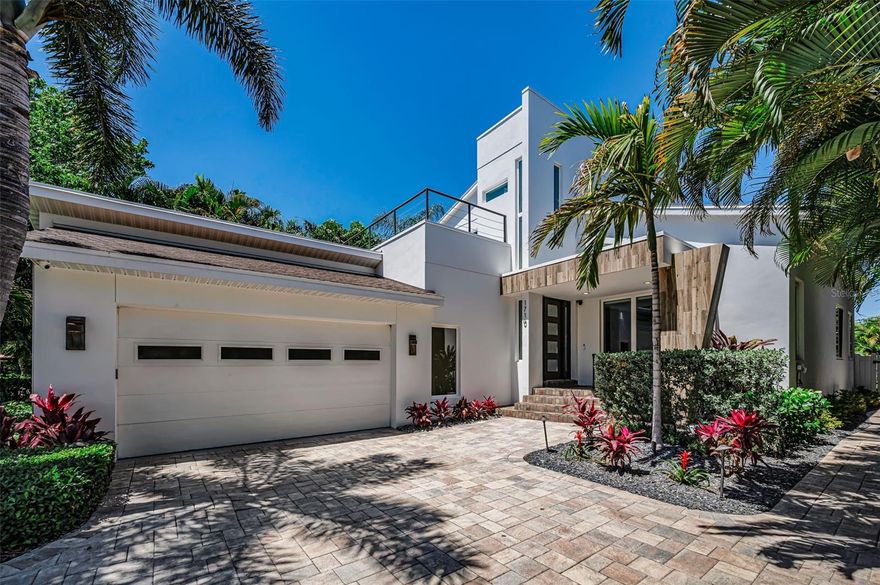 An exceptional expression of contemporary architecture, this 3,900-square-foot custom residence (built in 2014) is gracefully positioned within the highly desirable neighborhood of Snell Isle. Designed with a keen eye for sophistication and modern living, the home showcases striking curb appeal, framed by lush tropical landscaping and a stately paved drive. Step inside to rich hardwood flooring and an abundance of windows which flood the interiors with natural light, creating a luminous, gallery-like ambiance. The stunning great room is defined by dramatic vaulted ceilings and an effortless harmony of sophisticated entertaining and relaxed daily living. At the heart of the home, the chef’s kitchen is a statement of both form and function, featuring handcrafted wood cabinetry, exquisite granite surfaces, designer tile backsplash, and a full suite of professional-grade stainless steel appliances.  A substantial island with seating and an expansive walk-in pantry complete this culinary space, seamlessly opening to an elegant dining area. The main-level primary suite serves as a private sanctuary, enhanced by oversized windows and a spa-inspired ensuite with dual vanities and a walk-in glass and tile shower. A secondary ensuite bedroom on the main level offers flexibility as a guest retreat or executive office. Upstairs, two beautifully appointed guest suites share a refined bath featuring a built-in refrigerator, perfect for keeping skincare perfectly chilled.  Thoughtfully arranged in a mezzanine-style design overlooking the living space below. This home has been curated for elevated entertaining which features a striking indoor wet bar with vaulted ceilings and custom wood detailing, flowing effortlessly into a secluded outdoor oasis.  Here, a covered outdoor kitchen, multiple lounge areas, a gorgeous firepit, and lush landscaping create an atmosphere of privacy and resort-style tranquility. The newer constructed pool (2021) completes this exceptional outdoor experience.
Additional enhancements include soaring 10-foot ceilings, custom designer window treatments, and a detached 738-square-foot casita with a full bath and kitchenette providing a luxurious private retreat for guests or extended stays. Be prepared to fall in love. Ideally situated just moments from vibrant downtown, world-class beaches, and convenient airport access, this distinguished residence offers a rare opportunity to experience modern luxury at its finest.  Schedule a private tour today.