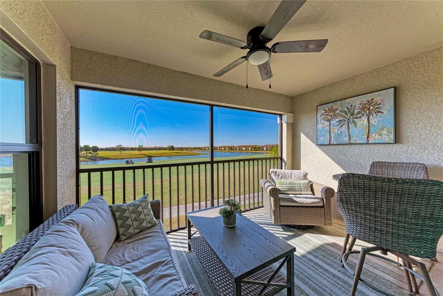 Golf membership included in the HOA and short-term rentals permitted! Experience luxury golf living in this beautifully appointed second-floor Veranda in Lakewood National Golf Club, offering sweeping golf course and lake views with spectacular sunset skies.

This highly desirable DiAngelo floorplan features 2 bedrooms, 2 baths, plus a versatile den/third bedroom with custom Murphy bed and built-in workspace, along with a private garage. The open-concept layout is light-filled and designed for both comfort and entertaining.

The designer kitchen showcases white cabinetry, quartz countertops, stainless steel appliances, 42" upper cabinets, and a spacious island with seating. Additional highlights include a frameless glass shower, smart-home entry with video doorbell and electronic lock, and elegant finishes throughout.

Enjoy true Florida indoor-outdoor living with two screened lanais in the front and rear—perfect for morning coffee or evening cocktails overlooking tranquil fairways and water views.

Located in the sought-after Verandas at Lakewood National, this maintenance-free residence includes a bundled golf membership and access to exceptional resort-style amenities:

• 36 holes of Arnold Palmer-designed championship golf
• 28,000 sq ft clubhouse with dining
• Resort-style lagoon pool with waterfalls
• Poolside tiki bar & café
• Full-service spa & fitness center
• Tennis, pickleball & bocce courts

Short-term rentals are permitted, offering excellent flexibility for personal use or investment potential.

Ideally located in Lakewood Ranch—America’s top-ranked multigenerational community, just minutes from UTC shopping and dining, I-75, Sarasota’s cultural attractions, and Gulf Coast beaches.