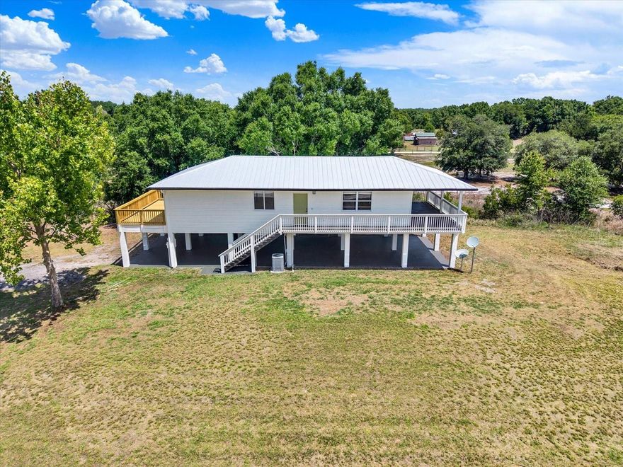 Escape to the peaceful lifestyle you’ve been dreaming of at 464 Logue Rd. Nestled on 5+ beautiful acres in the countryside, this charming stilt home with underground utilities offers the perfect blend of privacy, space, and convenience—exactly what today’s buyers have been searching for. Enjoy serene country living with room to roam, while still being just a short drive to major roads, shopping, dining, and everyday essentials. Located only steps away from southern horse/biking and hunting access gate of one of the top state protected preserves. Duette Preserve boasts 21,000 acres with deer, hog, coyote, turkey and quail hunting with seasonal passes. Unlimited horse back riding, bike riding and hiking for small pass fee. Headwaters of both the Manatee and Myakka River's are located within the preserve. This is nature's paradise you've been waiting for! Beneath the home, you’ll find abundant covered parking (1145sq ft) and storage space ideal for vehicles, boats, equipment, or creating the ultimate outdoor entertaining area. Inside, the home has been refreshed and updated with new kitchen & bathroom quartz counters and sink, new flooring, new paint, a new METAL roof in 2025, new HVAC in 2021 and new commercial pressure bladder tank on the well in 2025. What's not to love about the word "NEW"?!  Whether you’ve been searching for acreage, a move-in ready home, or the quiet country lifestyle without sacrificing convenience, this property checks all the boxes. Come experience the charm, space, and possibilities of this Myakka City gem.