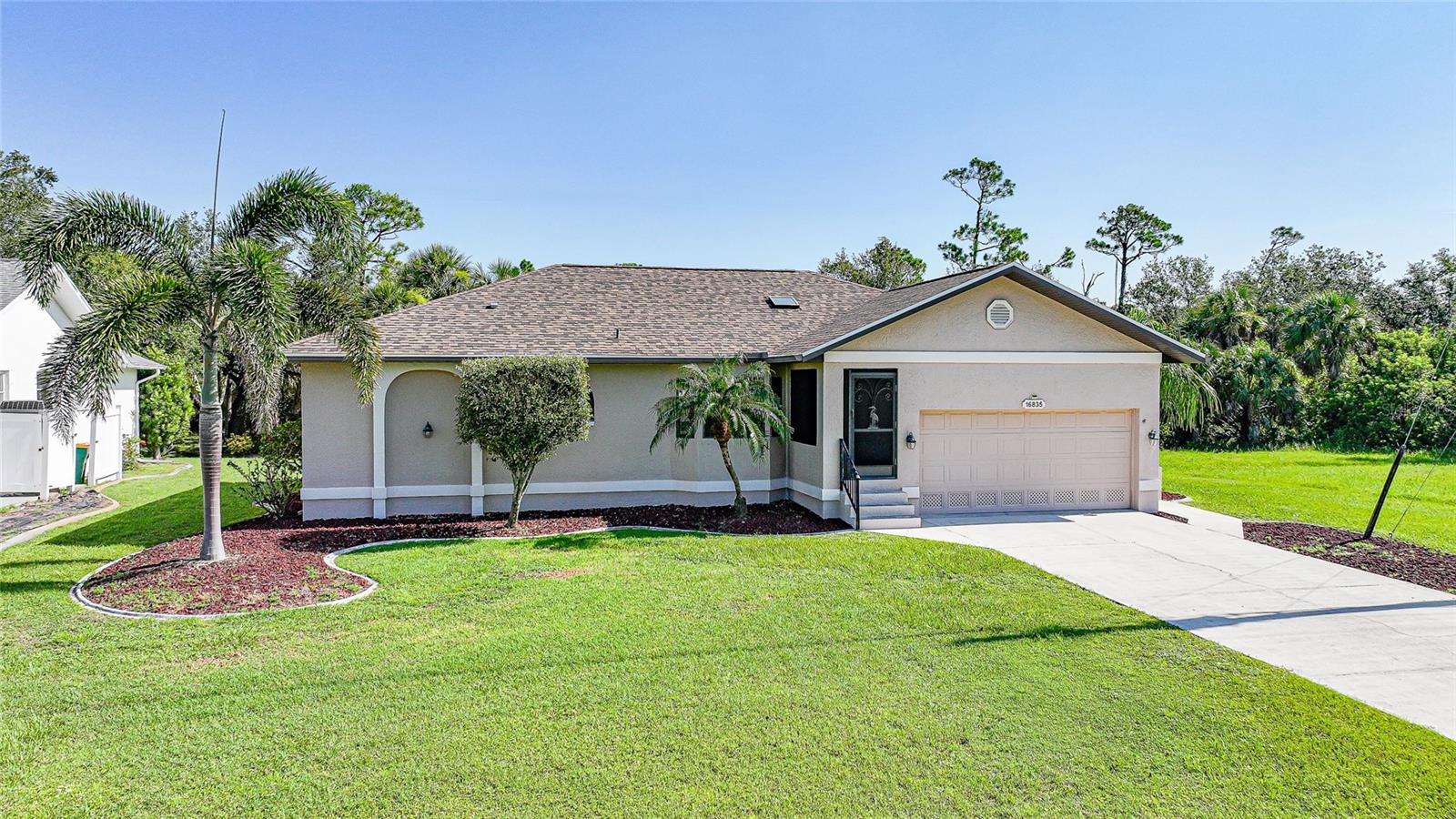Welcome to your slice of paradise in the highly sought-after community of Burnt Store Lakes! This 3-bedroom, 2-bathroom home offers 1,671 square feet of thoughtfully designed living space, combining comfort, style, and functionality. Step inside to find a light-filled interior featuring a skylight that brightens the main living area and a kitchen that overlooks the spacious living room, creating a seamless flow for entertaining or everyday living. The kitchen also offers a cozy dining space, perfect for casual meals or morning coffee with a view of the lush outdoors. Enjoy year-round peace of mind with impact-resistant windows and sliders throughout, and a roof replaced in 2022. The home is surrounded by beautiful, mature landscaping that adds privacy, curb appeal, and a touch of Florida charm. The southern rear exposure provides all-day sun—ideal for future outdoor upgrades like a pool or extended lanai. Situated on a generously sized lot with public utilities (city water and sewer), this home sits in a tranquil, deed-restricted neighborhood known for its serene lakes, natural beauty, and proximity to Charlotte Harbor and Burnt Store Marina. Whether you're looking for a full-time residence or seasonal retreat, this well-maintained home offers the perfect blend of features and location. Come see it for yourself—schedule your private showing today!