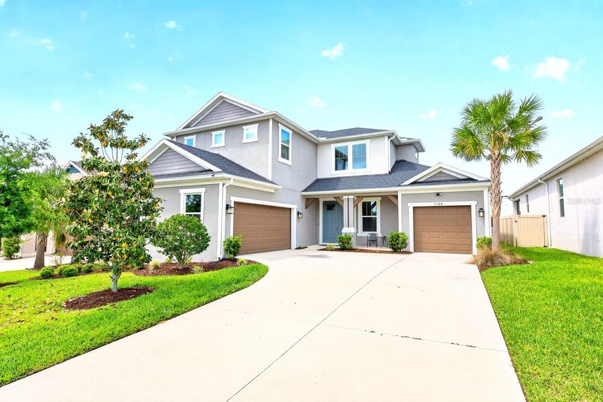 Welcome to this IMMACULATELY MAINTAINED 5-bedroom, 4.5-bath residence in the GATED LAKESIDE COMMUNITY of Apopka, where modern elegance meets everyday comfort across over 3,400 SQUARE FEET of thoughtfully designed living space. Built in 2022, this home still FEELS LIKE NEW and is truly MOVE-IN READY, with refreshed landscaping, a courtyard-style THREE-CAR GARAGE, and a charming front porch creating standout CURB APPEAL. Step inside to SOARING CEILINGS and a grand foyer, where your eye is immediately drawn to the elegant staircase and the open, airy layout beyond. WOOD-LOOK TILE FLOORING throughout the main living areas adds both style and durability, while the OPEN-CONCEPT DESIGN seamlessly connects the Living Room, Dining area, and Kitchen—perfect for both everyday living and entertaining. The Living Room is both stylish and inviting, complete with a modern ceiling fan, CUSTOM DRAPERY, and expansive THREE-PANEL POCKET SLIDING DOORS that open wide to blend indoor and outdoor living.The Kitchen is a TRUE SHOWPIECE, designed to impress with 42” cabinetry, sleek backsplash, BUILT-IN OVENS, stainless steel appliances, a generous breakfast bar, and an oversized pantry. The SUNNY DINING AREA is framed by windows, creating a warm and welcoming space for everything from casual mornings to elegant dinners. The main-floor Primary Suite is a PRIVATE RETREAT, offering serene backyard views and a SPA-INSPIRED en suite bath featuring dual vanities with a dedicated makeup area, a STYLISH GARDEN TUB, and an EXPANSIVE STEP-IN SHOWER with rainfall feature and dual bench seating. A secondary bedroom with its own EN SUITE on the first floor provides ideal accommodations for guests or multigenerational living. A HALF BATH and LAUNDRY ROOM complete the main level. Upstairs, a SPACIOUS BONUS ROOM provides flexible living space, perfect for a media room, playroom, or additional lounge area. Three additional generously sized bedrooms—ALL WITH WALK-IN CLOSETS—offer plenty of room for family or guests, including one with its own EN SUITE BATH, while the remaining two share a FOURTH FULL BATH. Step outside to enjoy the SCREENED REAR PATIO, where you can unwind while having your morning coffee or taking in the evening gentle breeze. The SPACIOUS BACKYARD is fully enclosed with VINYL FENCING, offering privacy and the perfect setting for outdoor gatherings, play, or relaxation. A SECURITY SYSTEM adds an extra layer of comfort and peace of mind. Residents of Lakeside enjoy RESORT-STYLE AMENITIES, including a sparkling community pool, playground, and lake dock, all within a welcoming neighborhood known for its friendly atmosphere and TOP-RATED SCHOOLS. Ideally located, you're not far from the natural beauty of WEKIWA SPRINGS STATE PARK and close to shopping, dining, and entertainment in Apopka and nearby WINTER GARDEN. You’re also within easy reach of charming downtown areas such as MOUNT DORA, known for its festivals, waterfront dining, and boutique shopping. With CONVENIENT ACCESS to major roadways like State Road 429 and State Road 414, commuting to Orlando and surrounding areas is quick and easy. This is MORE THAN JUST A HOME—it’s a place where style, space, and lifestyle come together beautifully. Schedule your tour today!