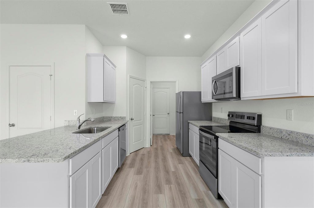Photo of 13245 Tula Loop, Astatula, FL 34705 (MLS # TB8550959)