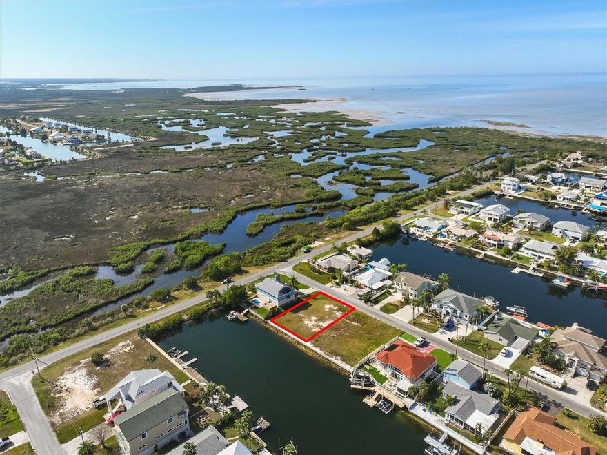 Watching Gulf Sunsets with Direct Gulf Access building lot!

Welcome to Hernando Beach, where your dream of coastal living meets the ultimate boater’s paradise. This exceptional direct Gulf access building lot offers incredible Gulf views and 77 feet of brand new concrete seawall on a saltwater canal with no fixed bridges standing between you and open water—ideal for serious anglers and boating enthusiasts alike. Imagine catching redfish, snook, and snapper right from your backyard while dolphins and manatees cruise by in the tide.

Located in the most desirable section of Hernando Beach, this rare property offers unrestricted boating access, gorgeous unobstructed marsh views, and no HOA or deed restrictions. That means short-term rentals are allowed, trailers and commercial vehicles are permitted, and privacy fencing up to 8 feet high is welcome.

This is the section of Hernando Beach that boaters covet most—where the saltwater canals rise and fall with the tides and lead straight to the Gulf of Mexico. Hernando Beach is a secluded coastal hamlet tucked away along Florida’s Nature Coast—quiet and private, yet only minutes to US-19 for shopping, dining, hospitals, and big-box conveniences. Tampa International Airport is just an hour away, and the magic of Orlando is only a 90-minute drive.

Explore world-class inshore and offshore fishing, indulge in fresh seafood from local markets, or enjoy a laid-back waterfront vibe with tiki bars and marinas just around the corner. Plus, you're only 5 minutes from the crystal-clear waters of Weeki Wachee Springs, perfect for kayaking, paddleboarding, and swimming year-round.

Whether you're looking to build your forever home, a weekend getaway, or a lucrative short-term rental, this lot offers endless possibilities. Come live the Gulf Coast fishing lifestyle where every tide brings new adventure.