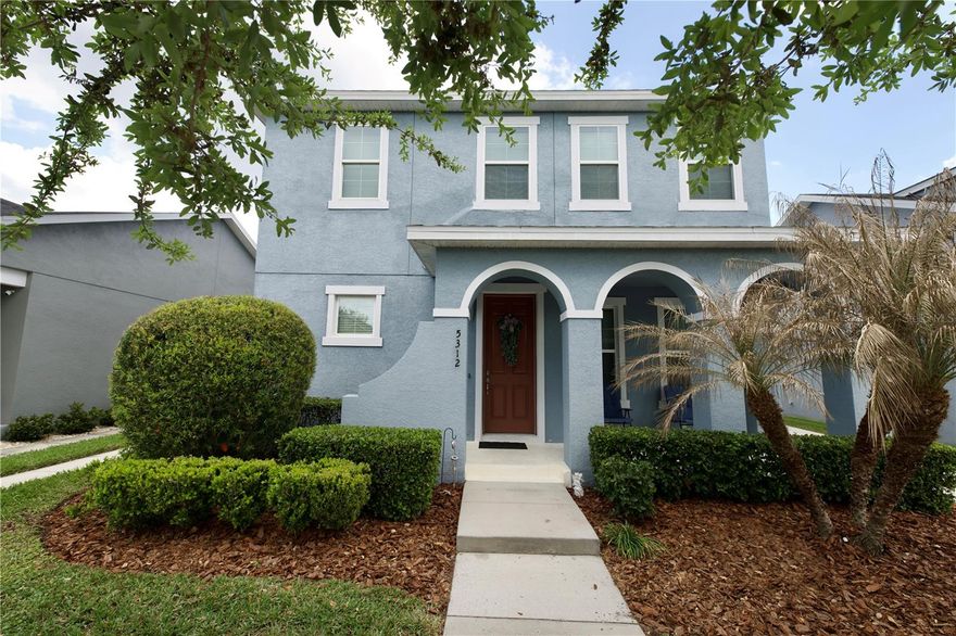 Welcome to this beautifully upgraded 4-bedroom, 3-bathroom home in the highly desirable Avalon Park West community. Offering 2,218 square feet of living space, this residence combines thoughtful design, modern finishes, and serene water views.

The home features a striking Spanish-style elevation with a charming front porch and mature landscaping that creates strong curb appeal. Inside, you are greeted by engineered wood-look porcelain flooring and a custom stone-accented fireplace, setting the tone for a warm and inviting living space.

The open-concept floor plan provides seamless flow between the living room, dining area, and kitchen, all enhanced by abundant natural light. The kitchen is well-appointed with 42-inch cabinetry, granite countertops, stainless steel appliances, decorative stone backsplash, and pendant lighting, making it ideal for both everyday living and entertaining.

A first-floor bedroom and full bathroom offer flexibility for guests, a home office, or multi-generational living. Upstairs, you’ll find a conveniently located laundry room, two additional bedrooms, and a spacious primary suite designed for comfort and privacy.

Step outside to the covered lanai overlooking the pond, where you can enjoy peaceful water views and a natural wooded backdrop. The property has a unique blend of waterfront living and privacy, a rare find in this area.