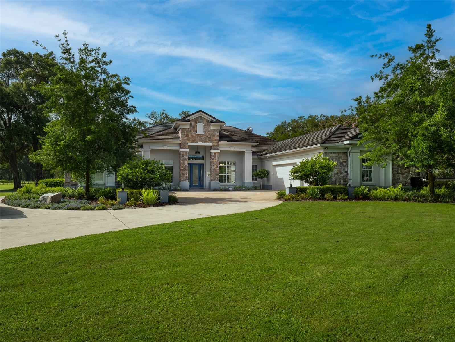 The quiet tree-lined roads leading to this is peaceful and private side of the Horse Capital of the World make Oak Haven Farm an idyllic backdrop for a peaceful home for your family and equine companions. This bucolic property is perfectly located to allow family and friends a busy day of showing or enjoying the Greenway trails while coming home to a serene, peaceful farm situated at the end of a quiet cul-de-sac surrounded by horse farms. This farm offers the perfect harmony of elegance and equine activity, a picturesque setting with a luxurious home perfect for entertaining or a comfortable, quiet meal with family and friends. For your horses, enjoy the brand-new 100 x 200 irrigated all weather arena with GGT footing and a stamped concrete seating patio, a 90x40 block barn with custom aluminum stall fronts, exterior doors, interior doors, central stereo, wash stall and large tack room complete with washer/dryer, powder room, AC/heat, custom cabinets, granite counter tops, flat screen TV, land line, and WIFI. Camera system on each stall and paddock. Five large paddocks with automatic waterers and shaded overhangs. Separate tractor bay with outside barn entrance. The newly created, illuminated gated entrance is striking, with double custom-made aluminum gates and custom-built stone columns of granite stone shipped south from a specialty quarry in Pennsylvania. The luxurious home renovations have been completed with all new Thermador appliances, and high-end finishes throughout, showcasing the comfortable floorplan and views and creating a sophisticated yet family-friendly home. Experience the elegant large format floor tiles throughout, all new Grohe faucets, showers, new and elegant chandeliers, fans, new inset kitchen cabinetry and high-end hardware, custom bathroom and closet cabinetry, and all quartzite counters. New custom trim work throughout, all new glass interior doors with high-end hardware. Outside covered pool area boasts a new kitchen with new marine grade cabinets, an oversized drop-in gas grill and granite countertops with seating. Featured with all new technology including central stereo, cameras, and security system. The large modern, linear gas fireplace with custom tile surround completes the stunning harmony of family gathering and elegance throughout this stunning home. Don’t miss this opportunity to own Oak Haven Farm and thoroughly enjoy both the activity and tranquility of the Horse Capital of the World.