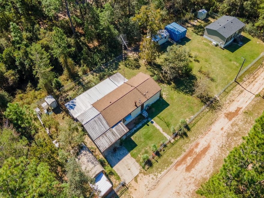 Peaceful Country Living Near Ocklawaha River – 14684 NE 204 Place, Fort McCoy, FL 32134
2 Bedrooms | 2 Bathrooms | 1,550 Sq Ft | .41 Fenced Acres | Florida Room & Deck

Welcome to this spacious and inviting home on .41 fenced acres, perfectly situated near the Ocklawaha River and surrounded by the beauty of the Ocala National Forest. This property combines privacy, comfort, and a connection to nature — ideal for those who love fishing, kayaking, or simply relaxing in a serene setting.

The home offers 2 bedrooms, 2 bathrooms, and 1,550 sq ft of living space with an open floor plan and cathedral ceilings. The main living area features laminate flooring, a large dining space, and a spacious kitchen that will impress with its abundant cabinetry, generous counter space, all appliances included, and an oversized pantry for storage.

Sliding glass doors lead from the main living area to a bright Florida room with laminate floors, large windows, and its own mini-split A/C unit—a perfect space for morning coffee or quiet evenings. Step outside to a 12'x16' covered deck, ideal for outdoor entertaining or enjoying peaceful views of the landscaped backyard.

The property is fully fenced and includes a concrete driveway, an attached covered carport, and multiple storage buildings. There are also metal planters ready for a garden, making it easy to grow your own flowers or vegetables.

Located just 20 minutes from downtown Fort McCoy, you’ll have easy access to groceries, gas, pharmacy, dining, and other essentials. Only a short drive to Silver Springs for major shopping and dining, and 45 minutes to Ocala or Palatka for additional amenities. Gainesville is an easy 50-minute drive for more entertainment and the University of Florida.

Outdoor enthusiasts will love the proximity to the Ocklawaha River, Salt Springs, Silver Glen Springs, and Juniper Springs, with endless opportunities for fishing, boating, hunting, hiking, horseback riding, and off-road adventures.

This well-maintained home offers space, comfort, and the best of Florida’s natural beauty — ready for new owners to enjoy!
