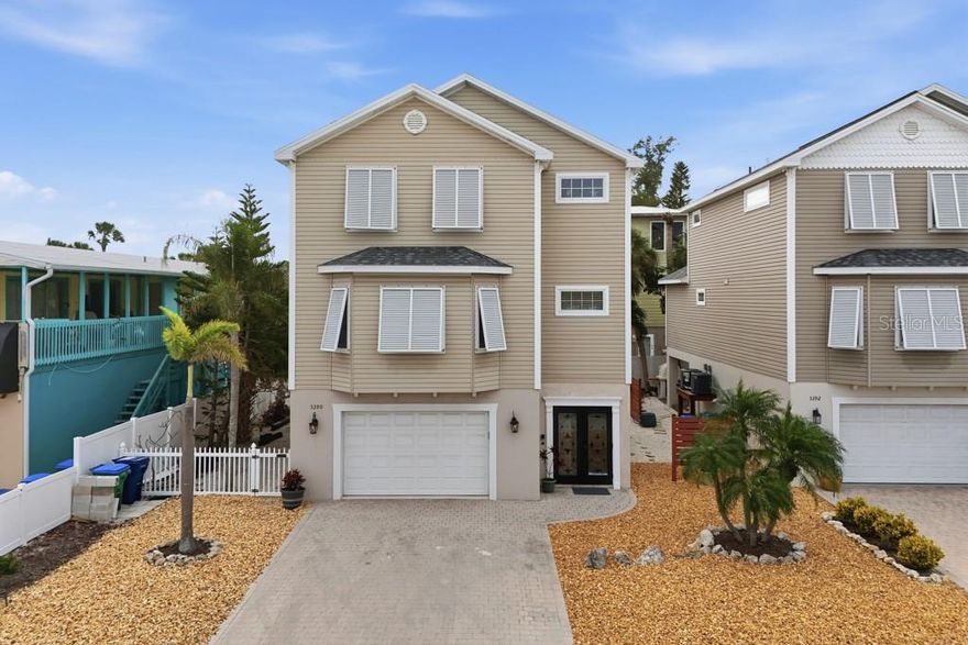 Just steps from the sugar white sands of the Gulf, this elevated coastal retreat captures the essence of relaxed beachside living with the comfort of thoughtful design. Bright, airy interiors welcome you with an open concept layout where the living area flows seamlessly into a charming kitchen featuring stainless steel appliances, beadboard cabinetry, and soft coastal hues that mirror the shoreline just beyond. The star of the home is the massive primary suite, perched privately on the top level with soaring ceilings, generous space for lounging or a reading nook, and an ensuite bath with a soaking tub and a walk-in shower. A second bedroom and a flexible den or office add versatility to the layout, easily adapting to your lifestyle needs. Step outside to a breezy balcony nestled among swaying palms, perfect for morning coffee or winding down after a day at the beach. Low maintenance tropical landscaping sets the tone for effortless island living, and the oversized garage offers ample room for all your beach gear. Whether you're seeking a full time residence, winter escape, or a dreamy vacation rental, this home delivers endless potential in an unbeatable location.