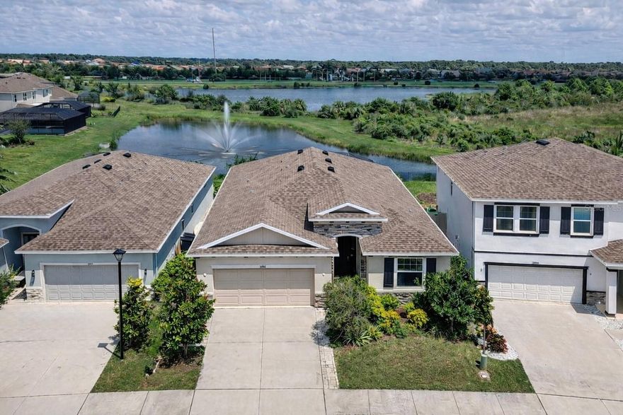 Former builder’s model on a premium lake-and-preserve lot in gated Promenade Estates at Palmer Ranch! This beautifully upgraded home offers serene pond, fountain, and preserve views from the main living areas and extended screened lanai. The open, light-filled floor plan features rich ceramic tile flooring and neutral finishes throughout. The chef’s kitchen is a standout with abundant cabinetry, stainless steel appliances, granite prep counters, pantry, and a huge granite island with breakfast bar seating—perfect for entertaining or casual dining. Enjoy added peace of mind with whole-home water filtration. Sliding glass doors lead to an extended, covered, and screened lanai a custom picture-window screen, delivering unobstructed water and preserve views—ideal for Florida indoor-outdoor living. The private primary suite is tucked away at the rear and features dual vanities, walk-in shower, soaking tub, private water closet, and dual walk-in closets. Bedrooms two and three provide comfortable guest accommodations with separate baths. A glass French-door office/den offers flexibility and can easily convert to a 4th bedroom. Additional features include an extended two-car garage and driveway, upgraded anti-no-see- um screening spacious laundry room with custom storage, ceiling fans throughout, Maytag water softener/purifier, and extensive paver upgrades. Promenade Estates offers resort-style amenities including a pool with lap lanes, fitness center, playground and splash pad, basketball and sand volleyball courts, dog parks with wash station, and picnic pavilion with grill. Just minutes to A-rated schools, world-class beaches, shopping, dining, and Sarasota’s cultural attractions. Move-in ready and rarely available—schedule your private showing today.