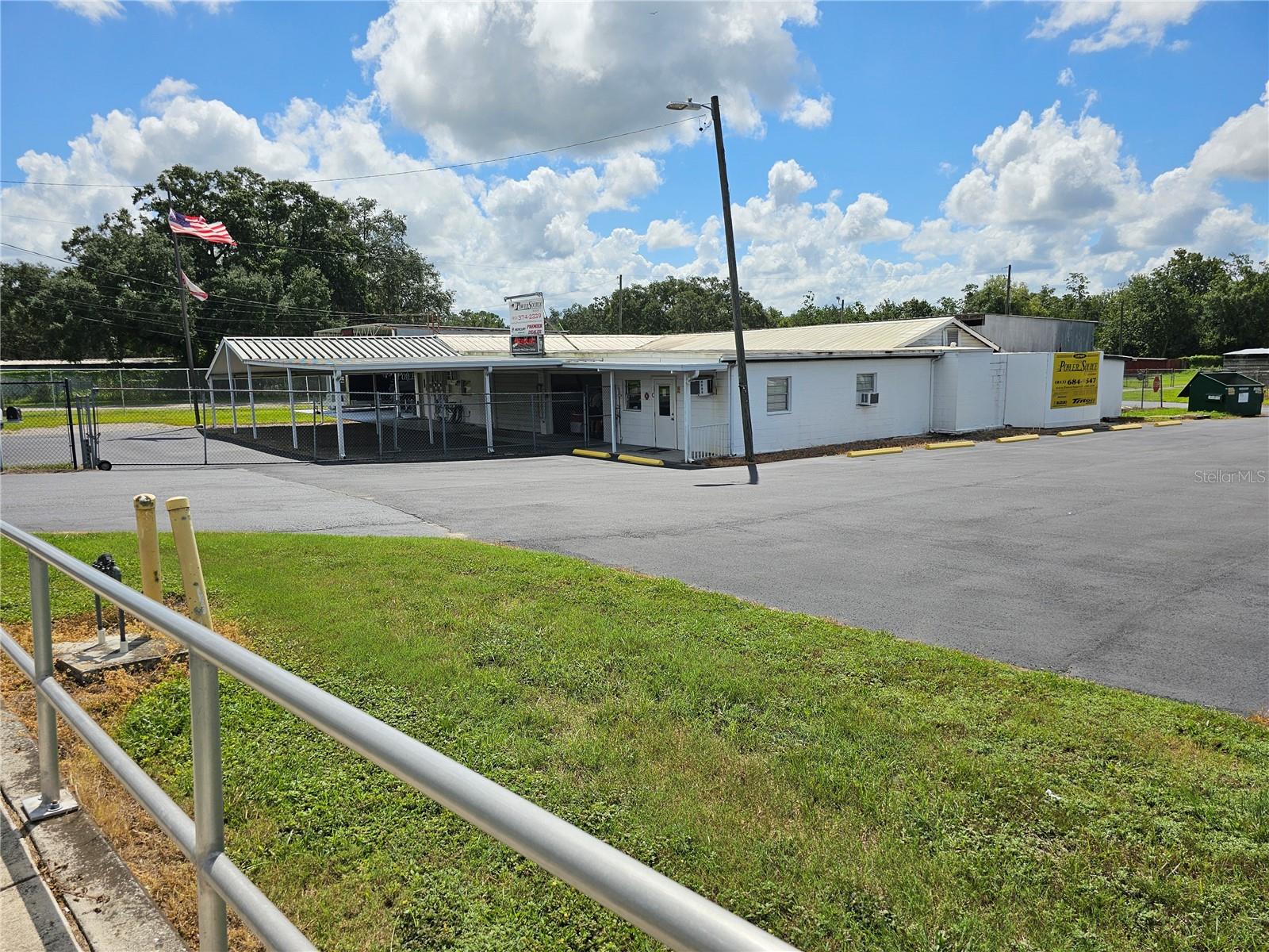 ATTRACTIVELY PRICED COMMERCIAL PROPERTY.!! What a Spectacular high visibility commercial business location. Next to a major lighted intersection on an extremely busy street in the heart of a business district. Enormous multi -use commercial space with reception, show room, offices, storage, parts warehouse, repair shop and so much more. There is secure fenced parking for special covered and open secure storage and parking needs. Alongside is an open extra large paved parking and storage with parking and storage for over 30 spaces. This is the retired location of a long-time boat sales, storage, service and repair facility for over 30 years. There is a sizeable air conditioned reception/sales counter and waiting area. An adjoining office is convenient for the support staff and has an ample files storage area. There are secure covered display areas for sales of boats, cars, RV, parts and many other uses, such as office complex, mini storage and more. There is a separate airconditioned executive office with a private and interior entrance. Need a machine shop? There are separate spaces customarily used for machine shops. There is a huge internal parts storage and warehouse area or can be easiy adapted to addition repair shops, machine shops or more. There are 4 enormous rear entry bays that are perfect for boat, automobile, motorcycle and RV servicing and repairs. There is a vehicle lift for servicing and repairs. Another bay has a sliding double hoist lift for movement of repairs to install or positioning equipment for installation and or repairs. Huge air movement fans makes the work area suitable for more comfortable repairs and service. There is a huge compressor for compressed air supply. An oils and lubricant collection and recycling tank is conveniently accessed. Ample storage thru out with additional storage trailer and equipment building adds convenience. A rear located fenced and secure parking and storage area adds another convenience for use. This is an exceptionally clean and ready to operate commercial showroom, display, sales and service center. The options are limitless. Great for Boats, Automobiles, RV's, Motorcycles, Trailer and Utility Building Sales, Service and Storage. Rent includes state sales taxes on the lease. Thousands of vehicle traffic daily. Great business location. There are multiple rental units on the property as well. Great location for redevelopment to office complex, warehouses, and/or mini storage complex. Come and See this Spectacular Commercial Center and Let's Make a Deal Today.. Call Now.