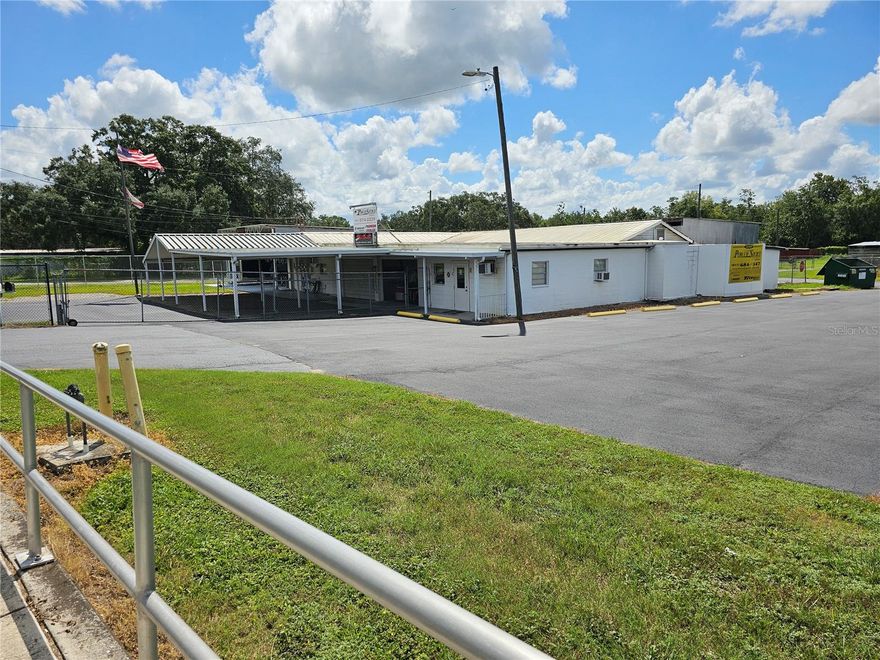 ATTRACTIVELY PRICED COMMERCIAL PROPERTY.!! What a Spectacular high visibility commercial business location. Next to a major lighted intersection on an extremely busy street in the heart of a business district. Enormous multi -use commercial space with reception, show room, offices, storage, parts warehouse, repair shop and so much more. There is secure fenced parking for special covered and open secure storage and parking needs. Alongside is an open extra large paved parking and storage with parking and storage for over 30 spaces. This is the retired location of a long-time boat sales, storage, service and repair facility for over 30 years. There is a sizeable air conditioned reception/sales counter and waiting area. An adjoining office is convenient for the support staff and has an ample files storage area. There are secure covered display areas for sales of boats, cars, RV, parts and many other uses, such as office complex, mini storage and more. There is a separate airconditioned executive office with a private and interior entrance. Need a machine shop? There are separate spaces customarily used for machine shops. There is a huge internal parts storage and warehouse area or can be easiy adapted to addition repair shops, machine shops or more. There are 4 enormous rear entry bays that are perfect for boat, automobile, motorcycle and RV servicing and repairs. There is a vehicle lift for servicing and repairs. Another bay has a sliding double hoist lift for movement of repairs to install or positioning equipment for installation and or repairs. Huge air movement fans makes the work area suitable for more comfortable repairs and service.  There is a huge compressor for compressed air supply. An oils and lubricant collection and recycling tank is conveniently accessed. Ample storage thru out with additional storage trailer and equipment building adds convenience. A rear located fenced and secure parking and storage area adds another convenience for use. This is an exceptionally clean and ready to operate commercial showroom, display, sales and service center. The options are limitless. Great for Boats, Automobiles, RV's, Motorcycles, Trailer and Utility Building Sales, Service and Storage. Rent includes state sales taxes on the lease.  Thousands of vehicle traffic daily. Great business location. There are multiple rental units on the property as well. Great location for redevelopment to office complex, warehouses, and/or mini storage complex. Come and See this Spectacular Commercial Center and Let's Make a Deal Today.. Call Now.