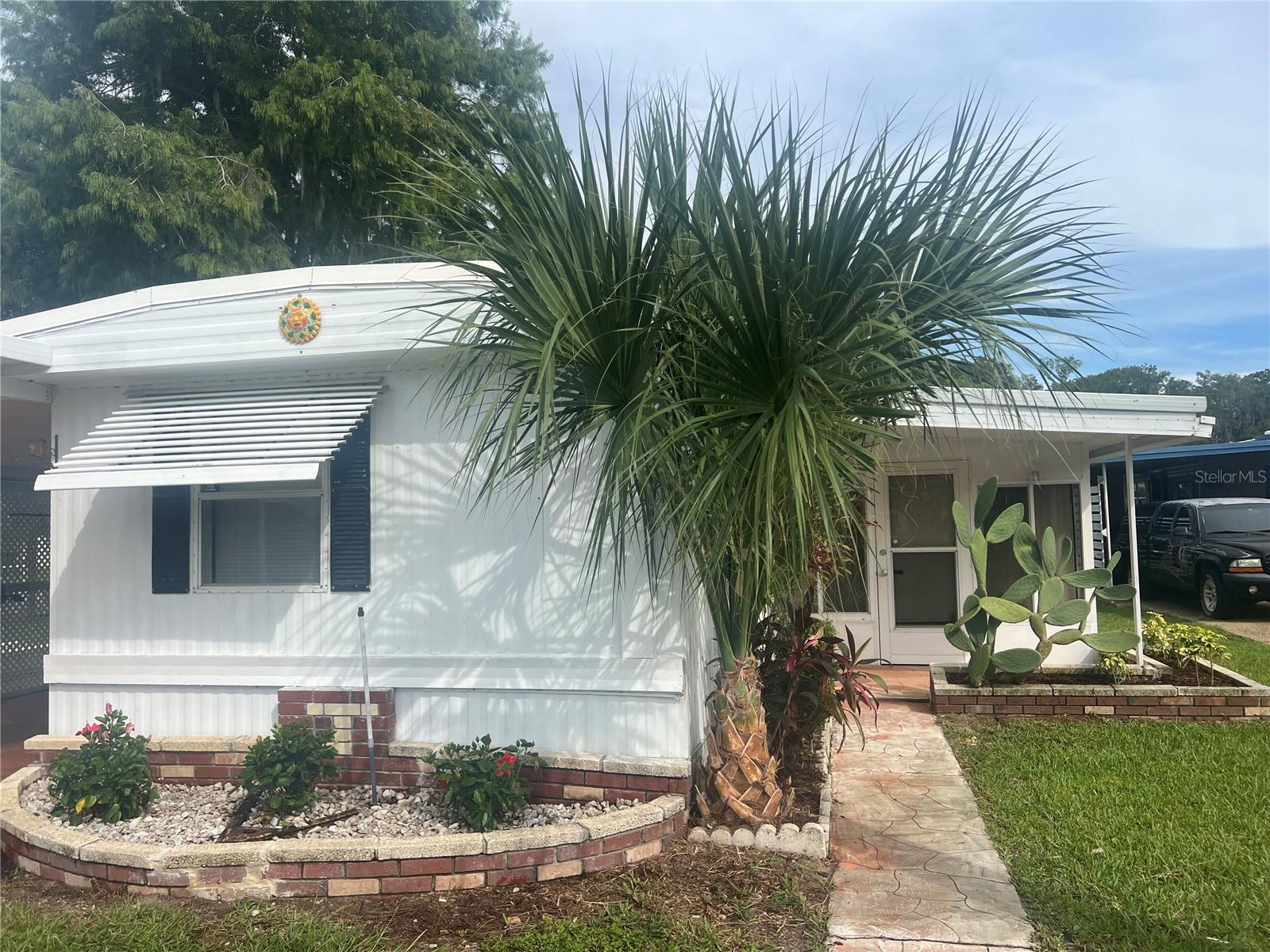 This WATERFRONT PROPERTY Is Located On The Dora Canal Which Is Part Of The Harris Chain Of Lakes. The Property Includes A Waterview And Covered Boat Slip With A Cradle And Aluminum Seawall. Enjoy Boating And Water Activities From Your Own Backyard. This Is A Must See For Those Seeking The Relaxed Florida Lifestyle At An Affordable Price. This Home Comes Complete With A Spacious And Open Living Area And Kitchen, Oversized Florida Room, Split Plan Bedroom Design, TWO SCREENED PORCHES, BOTH WITH WATER VIEWS, Inside Laundry, NOT ONE BUT THREE WORKSHOP/STORAGE UNITS WITH ELECTRICITY And A Covered Carport That Would Easily Fit Two Nice Size Cars Or A Car And Golf Cart. The Carport and Spacious Driveway Is Stamped Concrete. The Extras Include, A New 30-Gallon Hot Water Heater, Ceiling Fans In Every Room, A Ramp In The Florida Room For Easy Access, New Garbage Disposal, Gutters, Irrigation System, Smoke Detectors, Hurrican Straps, Water Softener and Rubber Membrane Roof. This Small And Intimate 55+ Community Boosts Low HOA Fees Which Includes Lawn Care and Water/Sewer/Trash. You Own The Land So There Are No Worries About Lot Rent Or Lot Rent Increases. Les Chateau Villa Community Amenities Include A Club House, Marina, Private Boat Ramp And Shuffleboard Courts To Name A Few. The Community Is Also Golf Cart Friendly. Perfect For Full Time Residents Or Snowbirds. Located Close To Shopping, Dining, Entertainment And Medical Facilities In Tavares, Leesburg, Eustis And Historic Mount Dora. Come Enjoy The Florida Lifestyle.