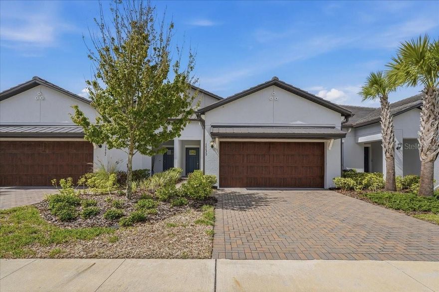 Fantastic opportunity to own a "newer" upgraded home at Angeline at a great price! Come and take a look at this pristine, upgraded home and make it your very own! This home has 2 bedrooms, 2.5 baths, plus a loft and a spacious 2 car garage. The home sits on a wonderful conservation lot with a water pond view creating a tranquil oasis to enjoy all day! The kitchen, with quartz countertops and stainless appliances is perfectly situated, giving you a full view of the living / dining room combination!  The primary bedroom is on the first floor, and upstairs you will find the 2nd bedroom with a loft - a great separate area for guests to enjoy full privacy! The home comes with a washer and dryer, new carpet in the bedrooms and loft, as well as epoxy flooring in the garage. Don't miss this chance to live at Angeline in Land O' Lakes, an active 55+ community with a resort style clubhouse featuring numerous amenities, including an on-site restaurant, community pool, fitness center, pickleball courts, shuffleboard, bocce ball, and so much more!