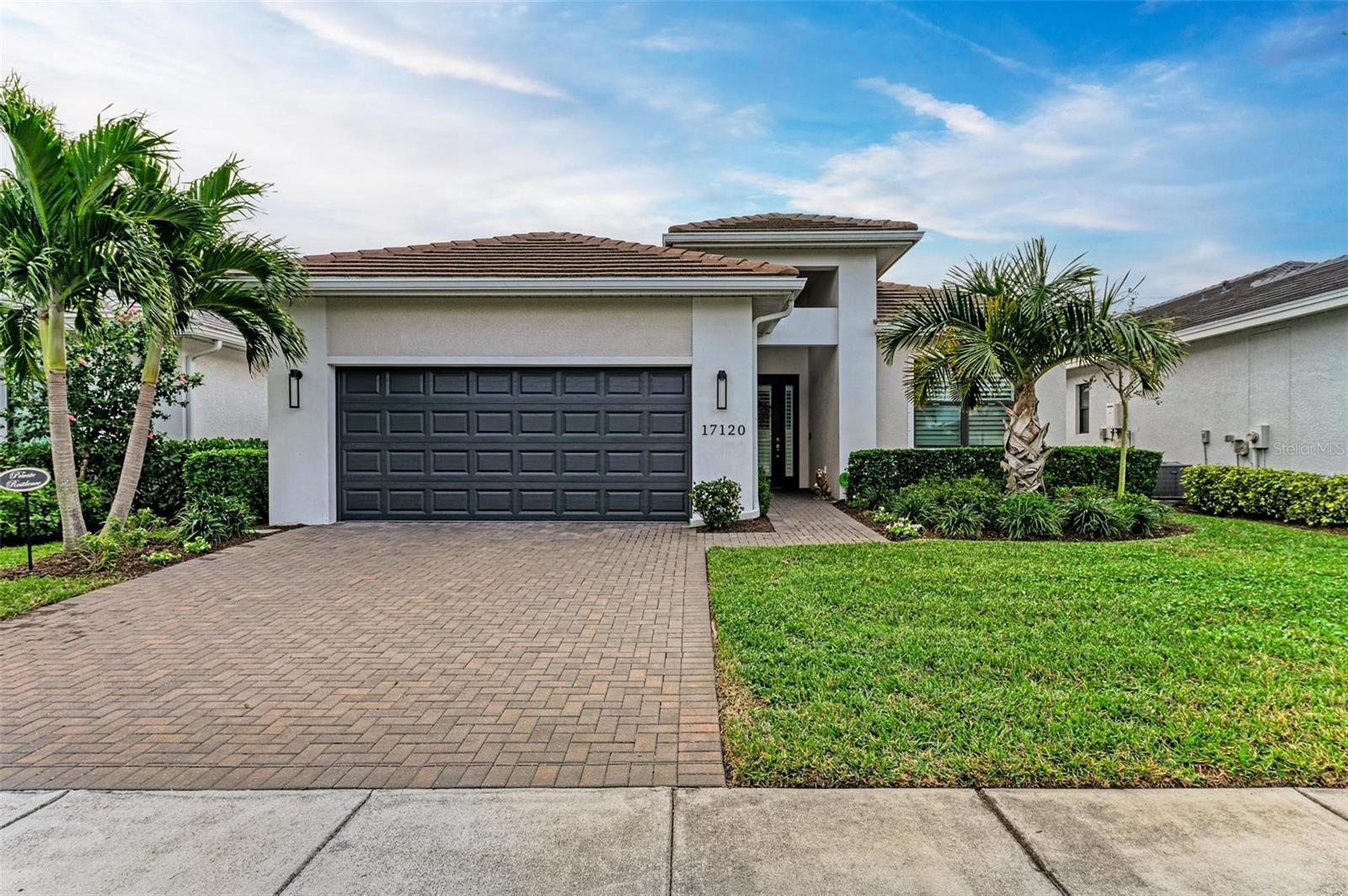 Major price drop and the BEST VALUE in Cresswind in this immaculate, model perfect, Green Certified home! This Fiesta model home by Kolter, has more than $125,000 in upgrades including built-ins in the kitchen and primary suite closet, 42” cabinets, quartz countertop, extended lanai, fans in all the rooms, tankless water heater, plantation shutters and a gas stub for an outdoor kitchen, to mention just a few. Additionally, the home features an open floor plan with a spacious great room, dining room and gourmet expansive island kitchen with all upgraded GE stainless steel appliances. The spacious primary suite in the rear of the home features dual solid surface vanities, oversized shower, and a large walk-in closet with built-ins. The two guest bedrooms are located at the front of the home offering privacy to both the guests and homeowners. You will also notice the beautiful tile throughout the main living areas of the home with the primary bedroom and den featuring newly installed luxury vinyl plank flooring. Additionally, this is a CERTIFIED FLORIDA GREEN HOME with a HERS rating of 52, providing substantial energy cost savings. The pet friendly community of Cresswind is an active 55+ community with plenty of activities and amenities. The resident-exclusive clubhouse is located directly across the street from this home for convenient access to the recreation center (with full-time lifestyle director), SmartFit/Egym, yoga studio, art studio, card rooms, pickleball and tennis courts, stunning heated resort pool, bocce courts and plenty of social clubs and activities. Why wait to build when you can move in now and begin enjoying your Florida lifestyle!