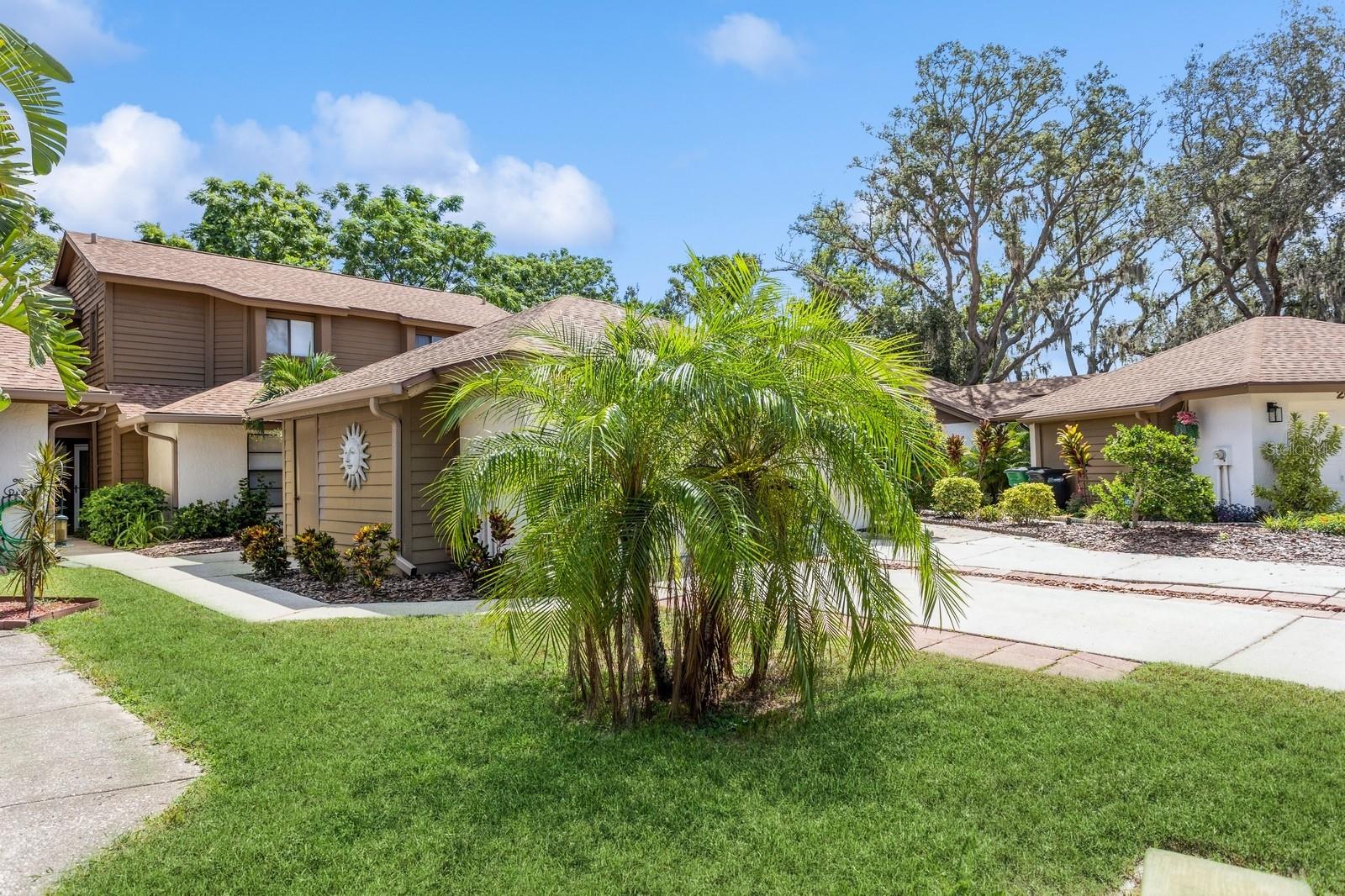 Enjoy Safety Harbor living to its fullest in this bright and modern townhome! This lovely retreat is located within the beautiful and tranquil Philippe Bay community, with its own entrance to the stunning Philippe Park on Old Tampa Bay, and mere minutes from the town’s vibrant Main Street. It is available turnkey and fully furnished, if desired. Upon pulling in to the secluded cul-de-sac and up the extra-long driveway, you will arrive at a roomy one-car garage with storage closet. Continue past a leafy green courtyard and through the front door to enjoy the sunlight streaming through the windows up to a soaring vaulted ceiling. A cozy yet expansive combined living/dining area is open and flexible, with a striking Koa ceiling fan and a dramatic double-height fireplace as its centerpiece. The upgraded kitchen features sparkling quartz countertops, white solid wood cabinetry with soft-close doors, drawers, and pull-out shelves, elegant hardware, and stylish pendant lighting. An expansive island is perfect for cooking and entertaining, and a small custom desk rounds out the space. Also included are a conveniently located pantry and laundry room. Enjoy the indoor/outdoor lifestyle by heading out to the spacious screened-in lanai through either of two sets of sliding glass doors. The private and quiet backyard features a vinyl fence with nothing but trees on the other side, perfect for relaxing and outside dining. Back inside, the large master suite with dual closets is handily located on the first floor, and the master bathroom feels spa-like with a wide quartz dual vanity, LED-lighted mirrors, custom cabinetry, walk-in shower, and full-sized tub. Upstairs, find a roomy loft with a wall of built-in bookcases, offering a versatile additional living space with a sizable walk-in closet. Also on this level are a second bedroom and full-sized guest bathroom. Adding to the desirability of this townhome is the low $176/month HOA, which includes a community pool, tennis/pickleball courts, BBQ area, private park entrance, and cable/internet. Philippe Park offers both waterside and forested walking trails sheltered by mature moss-draped oak trees, as well as playgrounds, boat, kayak, and paddleboard launches, picnic pavilions, and a bike trail that connects to Ream Wilson Trail via North Bayshore Drive. The nearby Safety Harbor downtown and waterfront area is a serene seaside escape that boasts attractions such as the Market on Main every Sunday, Third Fridays, and numerous other street festivals throughout the year. Main Street itself features great restaurants, craft breweries, wine bars, coffee shops, galleries, and much, much more. Don’t miss your chance to own a coveted unit in this captivating community by the bay. Schedule your showing today!